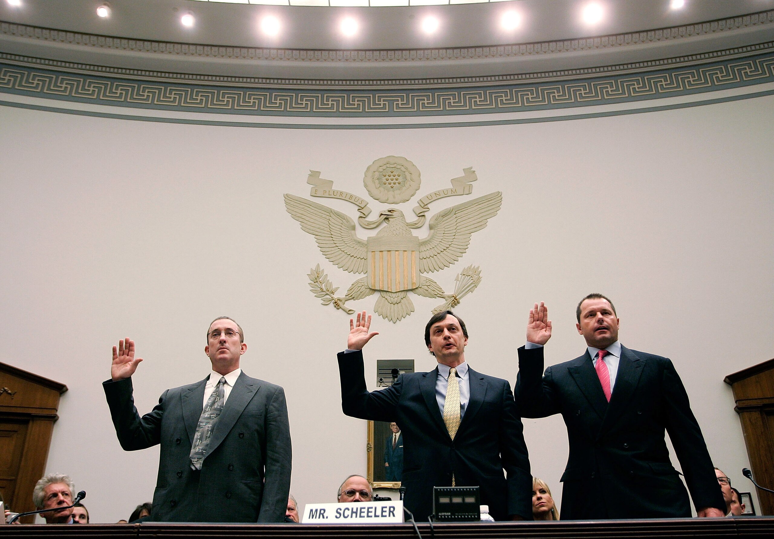 WASHINGTON - FEBRUARY 13:  Major League Baseball pitcher Roger Clemens (R), Charlie Scheeler, investigator on former Sen. George Mitchell's staff (C) and and former Major League Baseball strength and conditioning coach Brian McNamee (L) raise their right