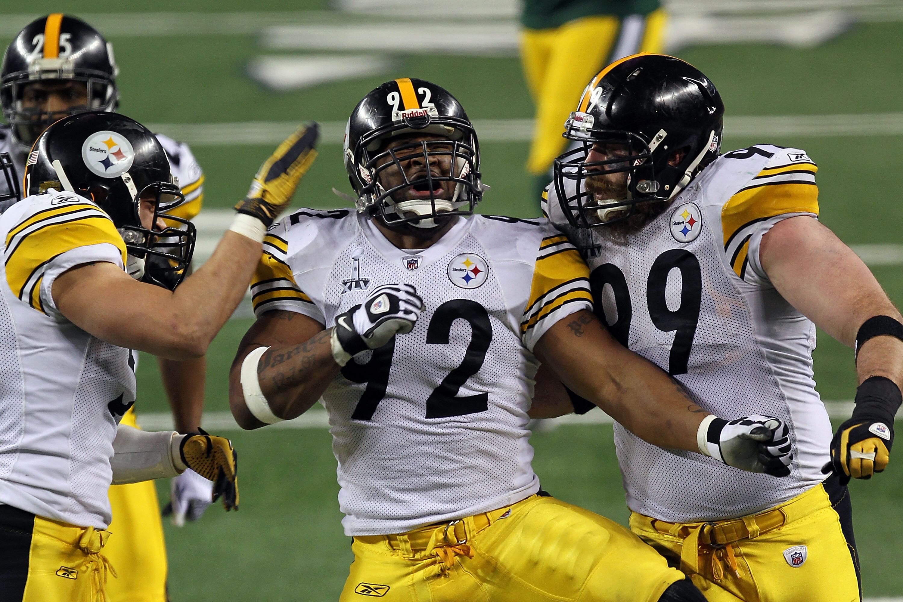 ARLINGTON, TX - FEBRUARY 06:  James Farrior #51, James Harrison #92 and Brett Keisel #99 of the Pittsburgh Steelers celebrate a defensive play against the Green Bay Packers during Super Bowl XLV at Cowboys Stadium on February 6, 2011 in Arlington, Texas.