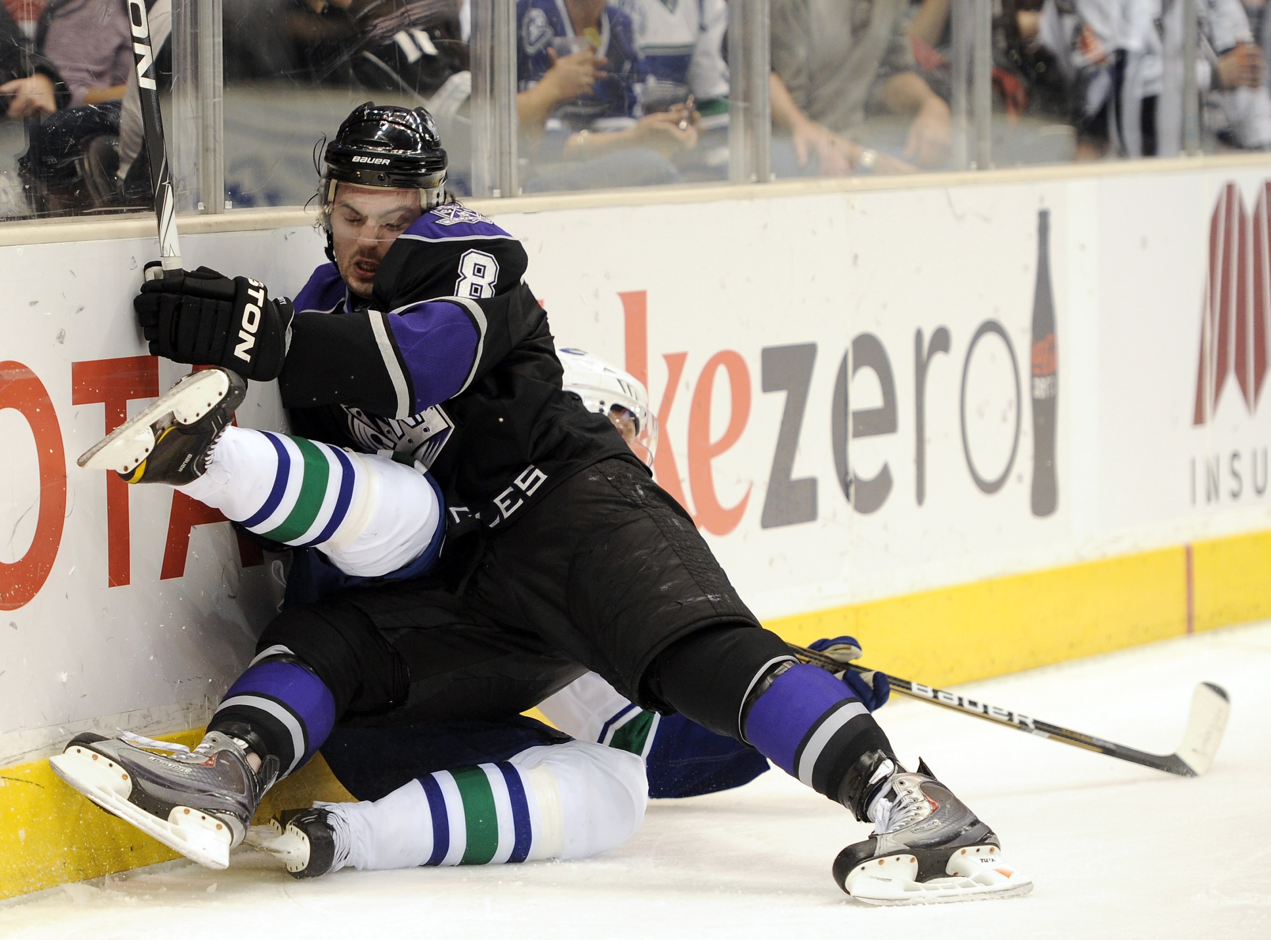 LOS ANGELES, CA - MARCH 05:  Drew Doughty #8 of the Los Angeles Kings knocks over Daniel Sedin #22 of the Vancouver Canucks at the Staples Center on March 5, 2011 in Los Angeles, California.  (Photo by Harry How/Getty Images)
