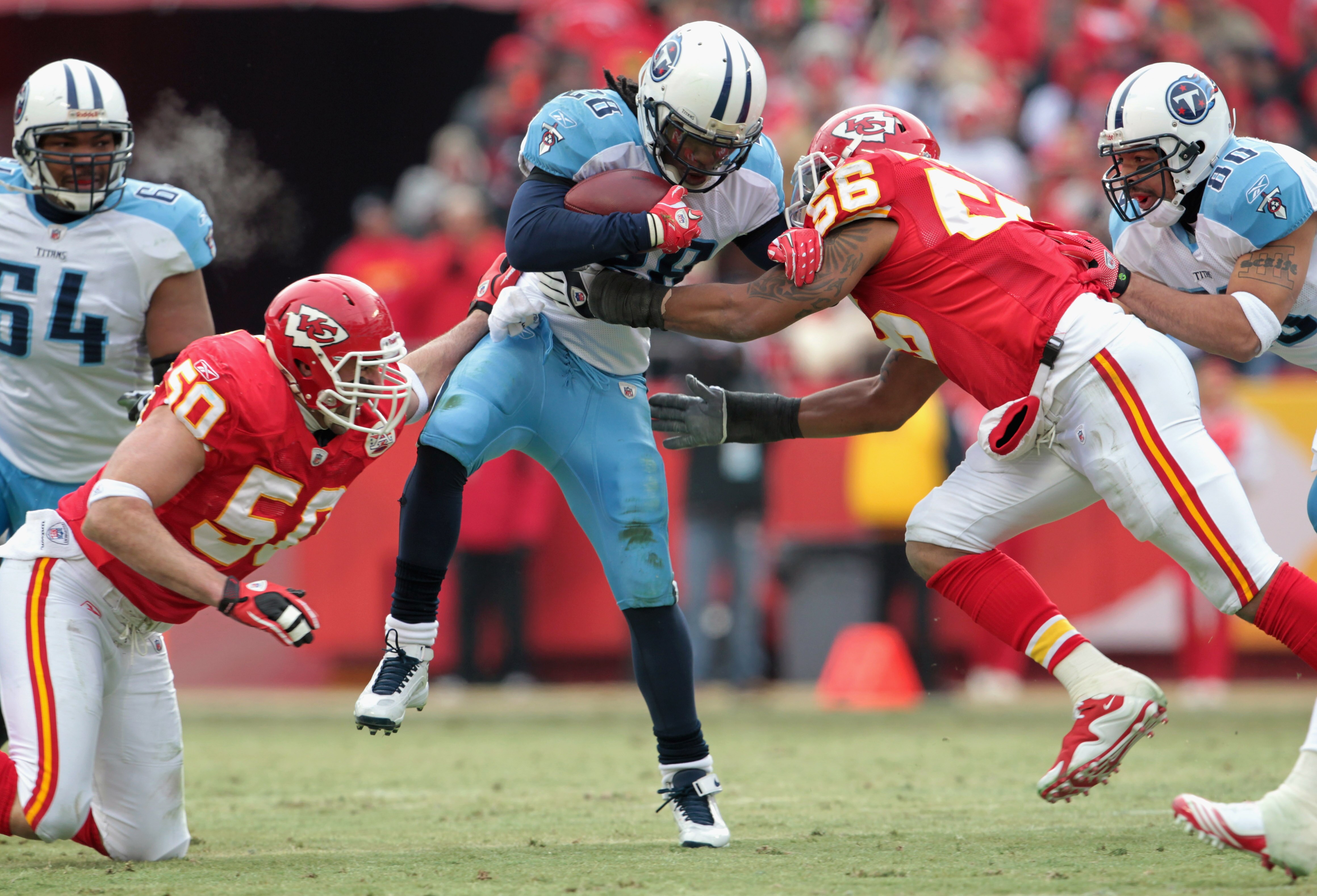 KANSAS CITY, MO - DECEMBER 26:  Chris Johnson #28 of the Tennessee Titans carries the ball as Mike Vrabel #50 and Derrick Johnson #56 of the Kansas City Chiefs defend during the game on December 26, 2010 at Arrowhead Stadium in Kansas City, Missouri.  (Ph