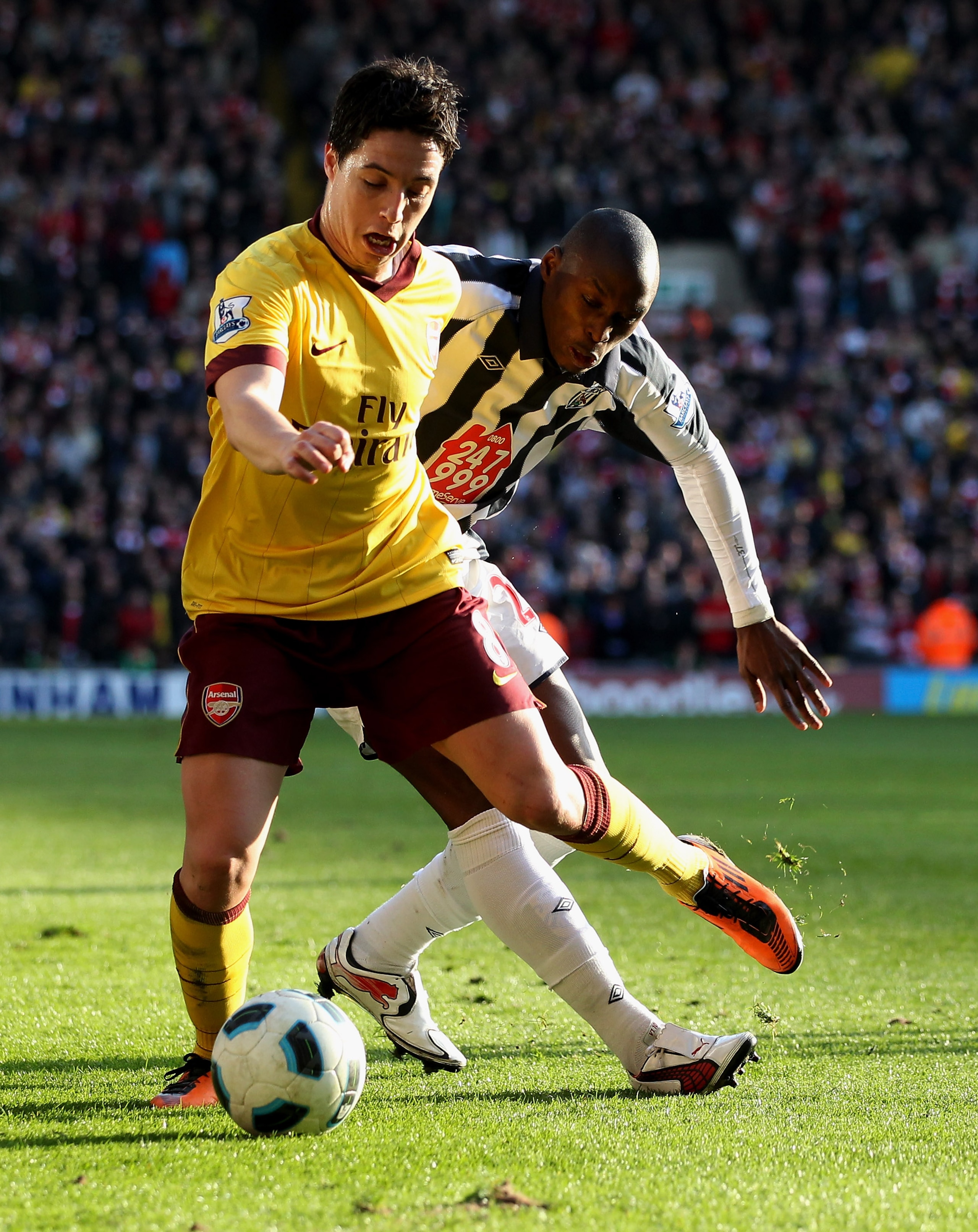 WEST BROMWICH, ENGLAND - MARCH 19:  Samir Nasri of Arsenal (L) in action with Marc-Antoine Fortune of WBA at The Hawthorns on March 19, 2011 in West Bromwich, England.  (Photo by Scott Heavey/Getty Images)