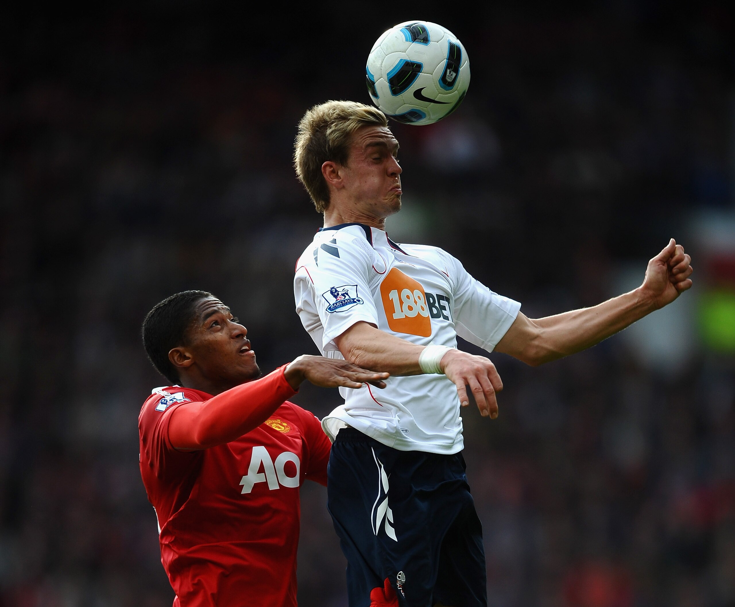 MANCHESTER, ENGLAND - MARCH 19: Antonio Valencia of Manchester United battles with Stuart Holden of Bolton Wanderers during the Barclays Premier League match between Manchester United and Bolton Wanderers at Old Trafford on March 19, 2011 in Manchester, E