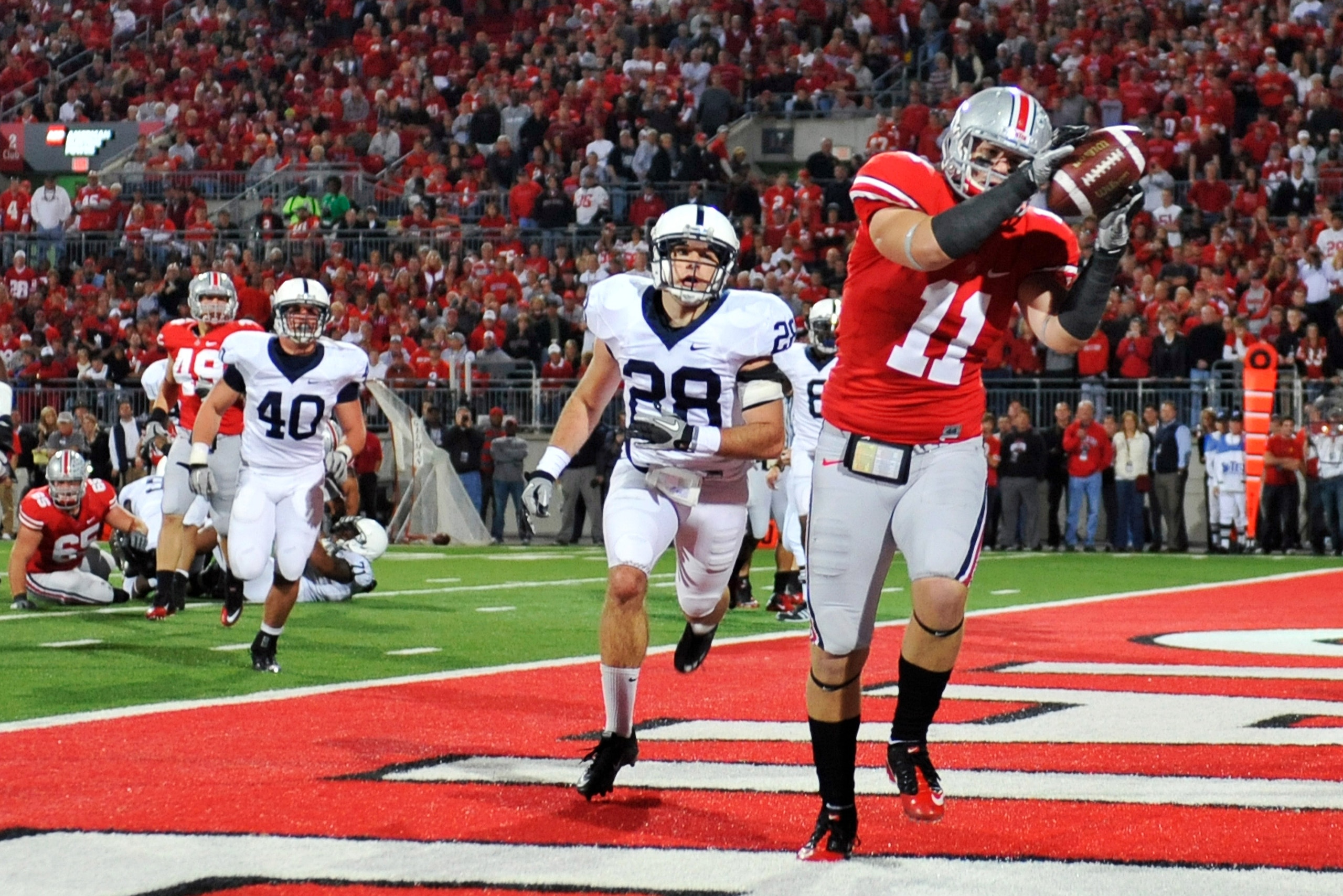 COLUMBUS, OH - NOVEMBER 13: Jake Stoneburner #11 of the Ohio State Buckeyes makes a three yard touchdown reception in front of Drew Astorino #28 of the Penn State Nittany Lions at Ohio Stadium on November 13, 2010 in Columbus, Ohio. Ohio State defeated P COLUMBUS, OH - NOVEMBER 13: Jake Stoneburner #11 of the Ohio State Buckeyes makes a three yard touchdown reception in front of Drew Astorino #28 of the Penn State Nittany Lions at Ohio Stadium on November 13, 2010 in Columbus, Ohio. Ohio State defeated P