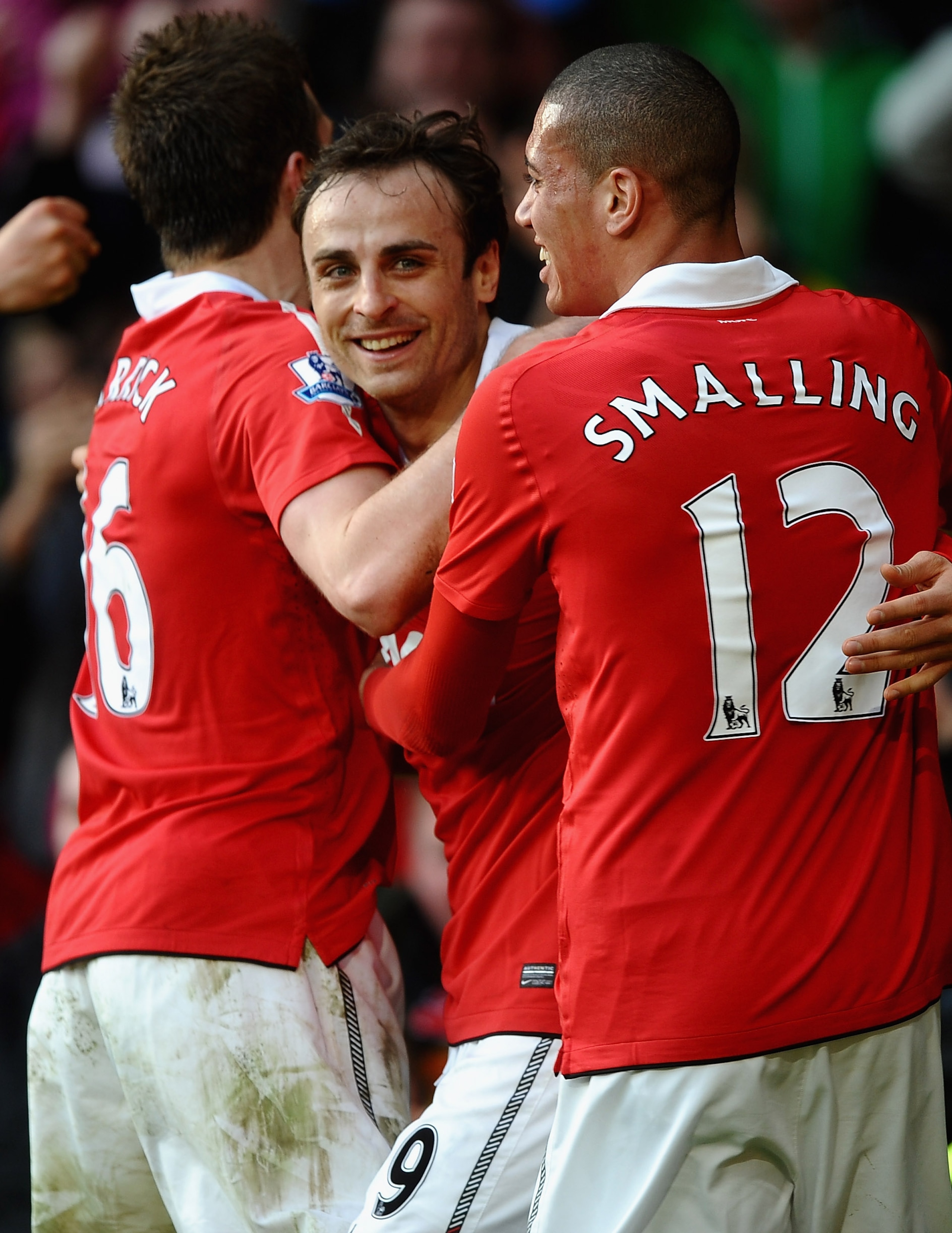 MANCHESTER, ENGLAND - MARCH 19: Dimitar Berbatov of Manchester United is congratulated on scoring the winning goal by Michael Carrick and Chris Smalling during the Barclays Premier League match between Manchester United and Bolton Wanderers at Old Traffor
