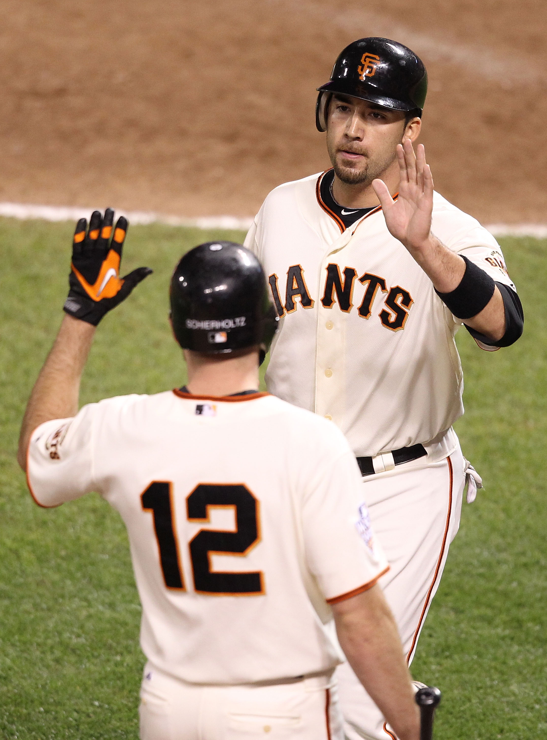 SAN FRANCISCO - OCTOBER 27:  Travis Ishikawa #10 of the San Francisco Giants celebrates with Nate Schierholtz #12 after scoring in the eighth inning against the Texas Rangers in Game One of the 2010 MLB World Series at AT&T Park on October 27, 2010 in San