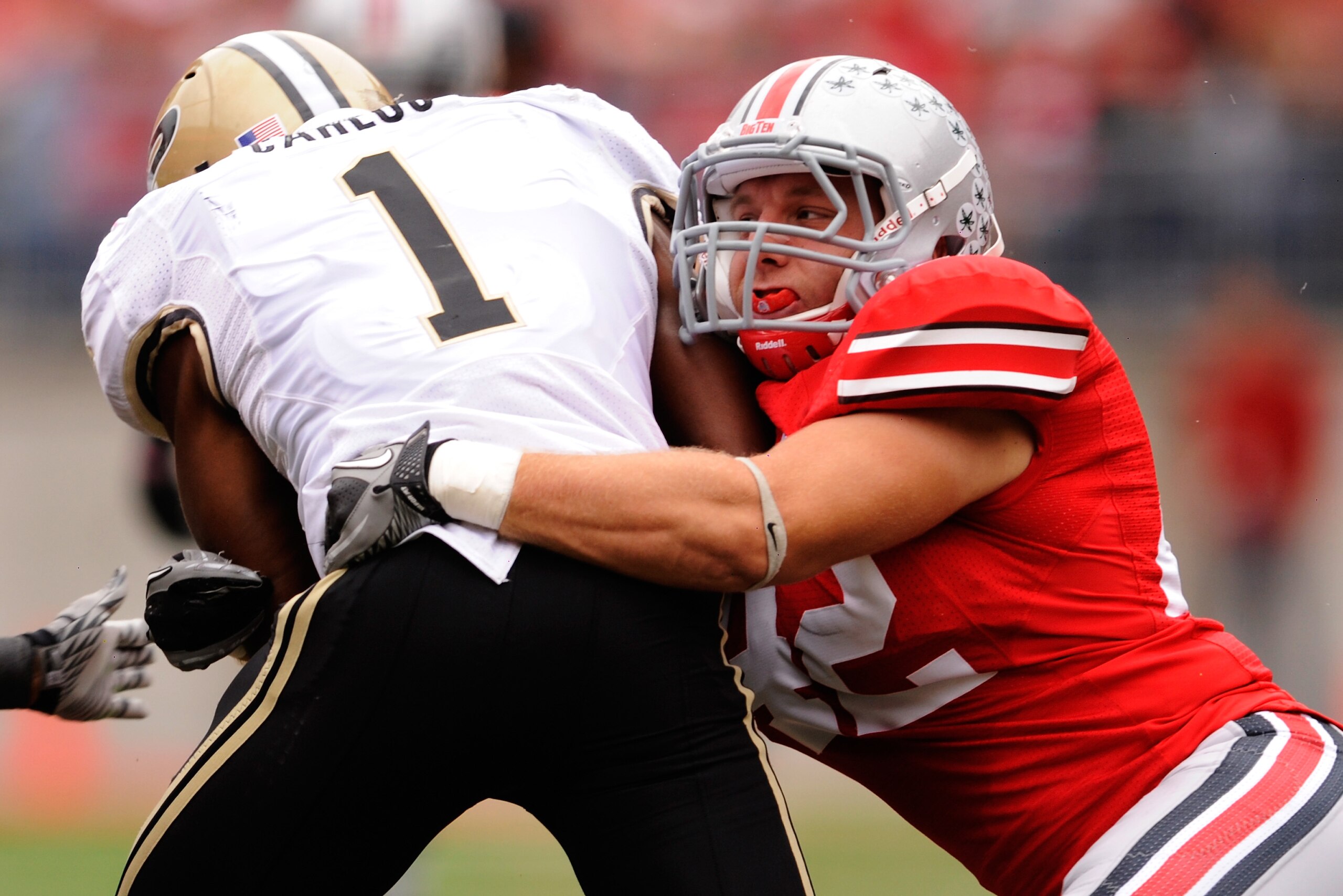 COLUMBUS, OH - OCTOBER 23: Running back Keith Carlos #1 of the Purdue Boilermakers is tackled by Andrew Sweat #42 of the Ohio State Buckeyes at Ohio Stadium on October 23, 2010 in Columbus, Ohio. (Photo by Jamie Sabau/Getty Images) COLUMBUS, OH - OCTOBER 23: Running back Keith Carlos #1 of the Purdue Boilermakers is tackled by Andrew Sweat #42 of the Ohio State Buckeyes at Ohio Stadium on October 23, 2010 in Columbus, Ohio. (Photo by Jamie Sabau/Getty Images)