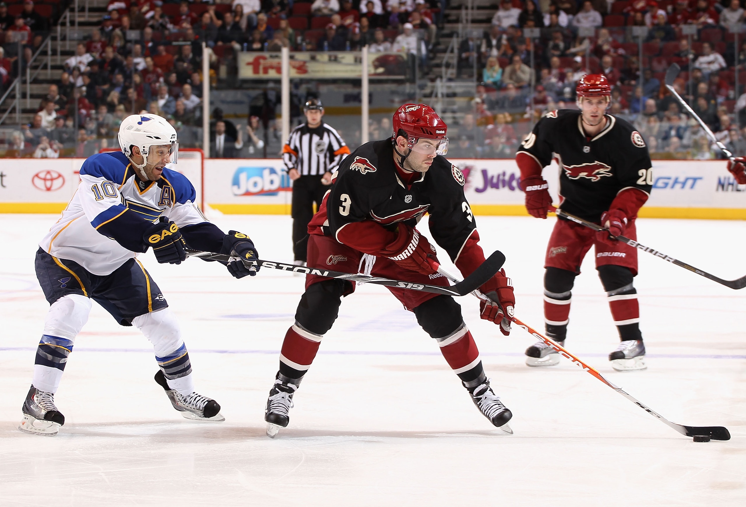 GLENDALE, AZ - MARCH 22:  Keith Yandle #3 of the Phoenix Coyotes skates with the puck under pressure from Andy McDonald #10 of the St. Louis Blues during the second period of the NHL game at Jobing.com Arena on March 22, 2011 in Glendale, Arizona.  (Photo