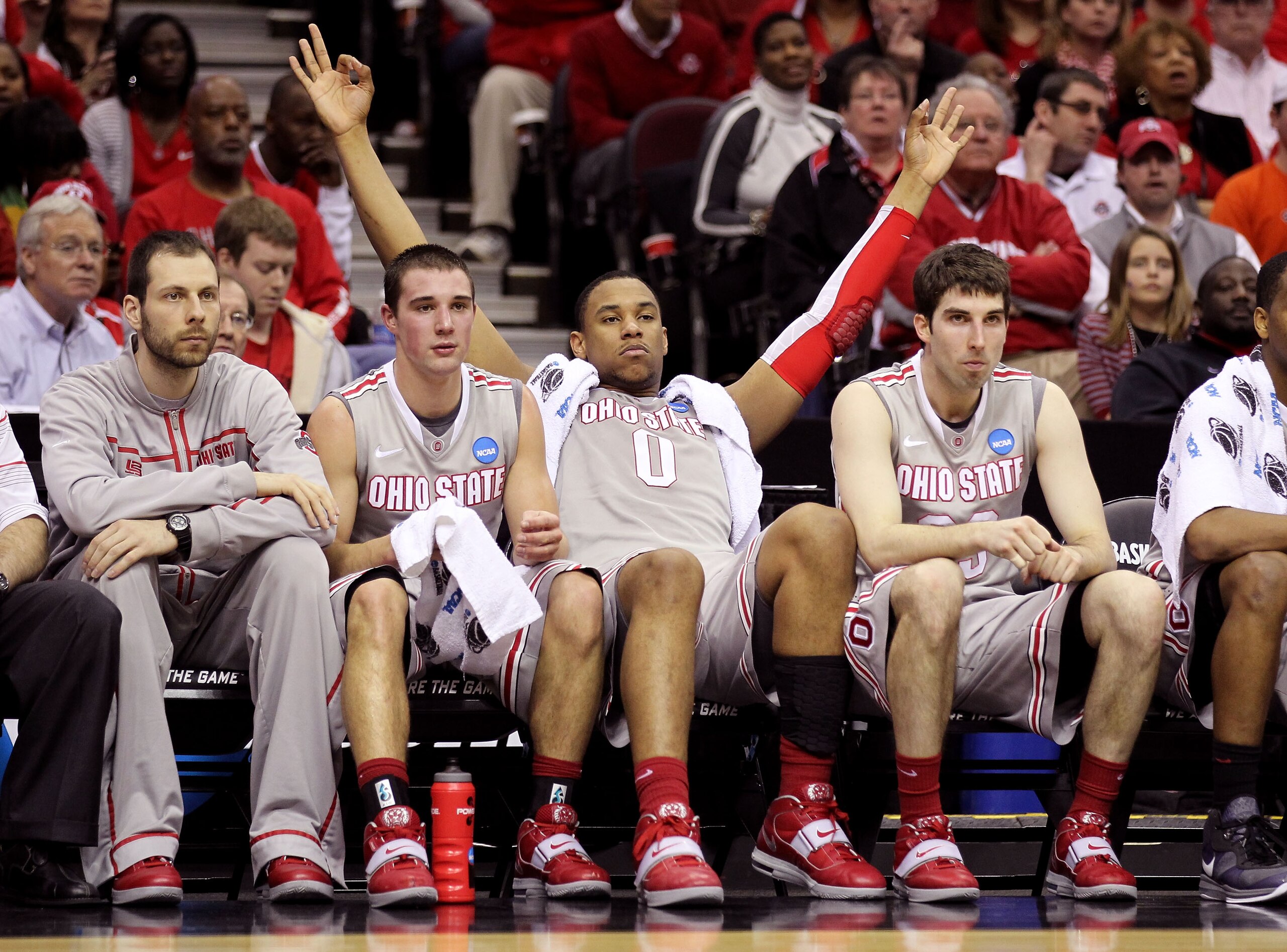 CLEVELAND, OH - MARCH 20: Aaron Craft #4, Jared Sullinger #0 and Jon Diebler #33 of the Ohio State Buckeyes look on from the bench late in the second half against the George Mason Patriots during the third of the 2011 NCAA men's basketball tournament at Q