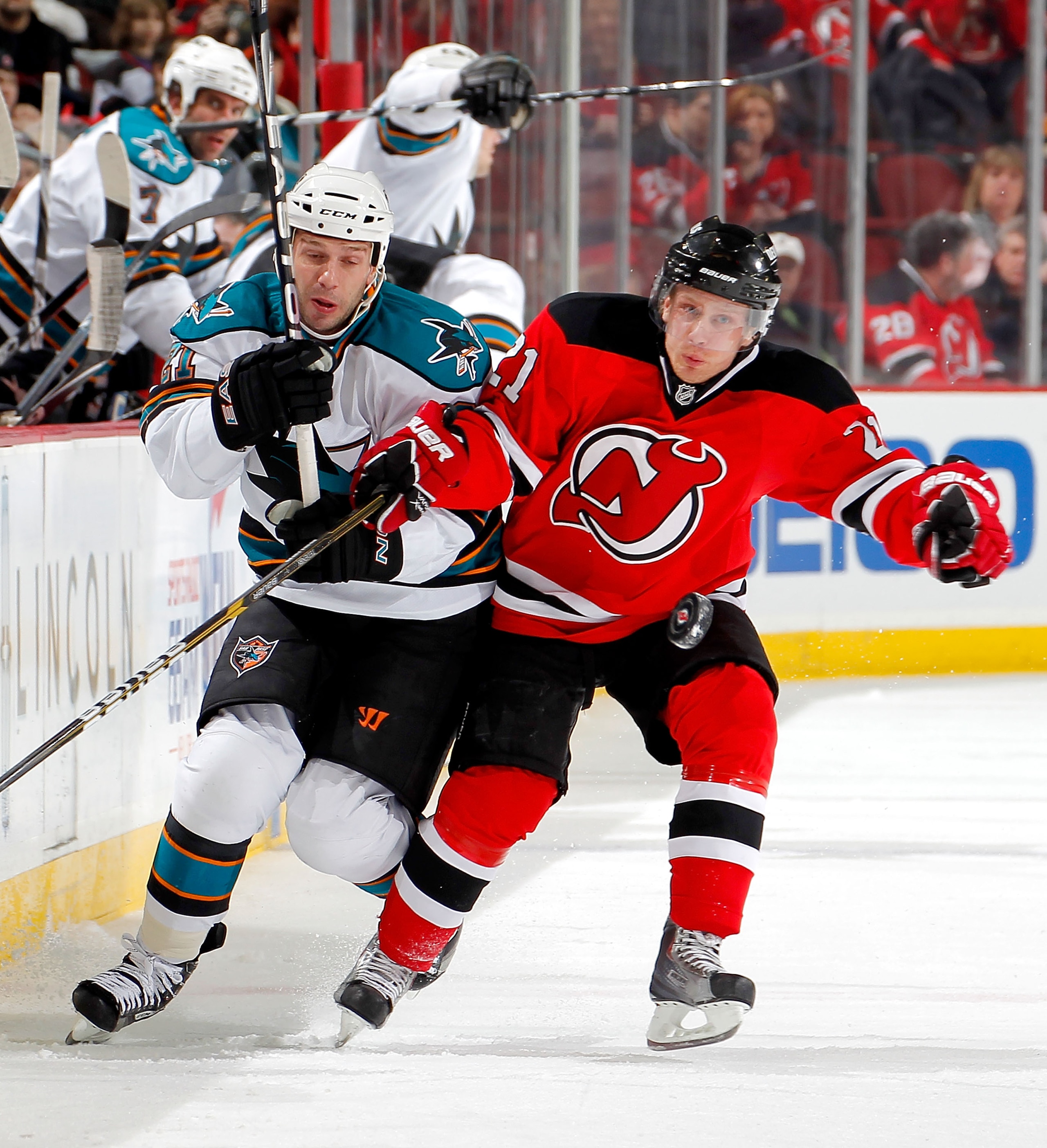NEWARK, NJ - FEBRUARY 11: Scott Nichol #21 of the San Jose Sharks skates after the puck with Mattias Tedenby #21 of the New Jersey Devils during an NHL hockey game on February 11, 2011 at the Prudential Center in Newark, New Jersey. (Photo by Paul Bereswi