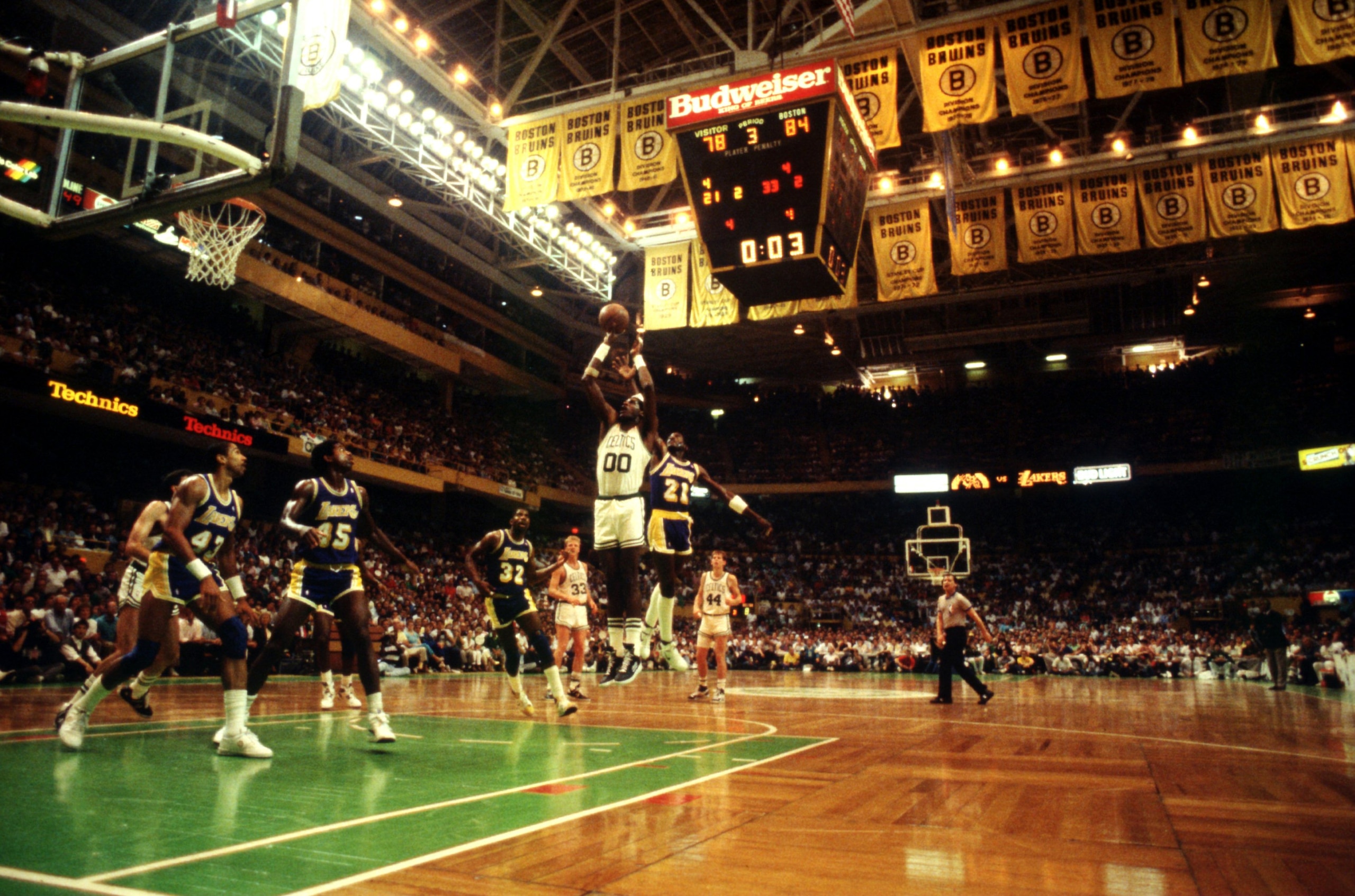 JUN 1987:  BOSTON CENTER ROBERT PARISH SHOOTS WITH 0:03 SECONDS LEFT IN THE third QUARTER AS LOS ANGELES GUARD MICHAEL COOPER TRIES TO BLOCK THE SHOT FROM BEHIND DURING CELTICS VERSUS LAKERS GAME IN THE NBA FINALS AT THE BOSTON GARDEN IN BOSTON, MASSACHUS