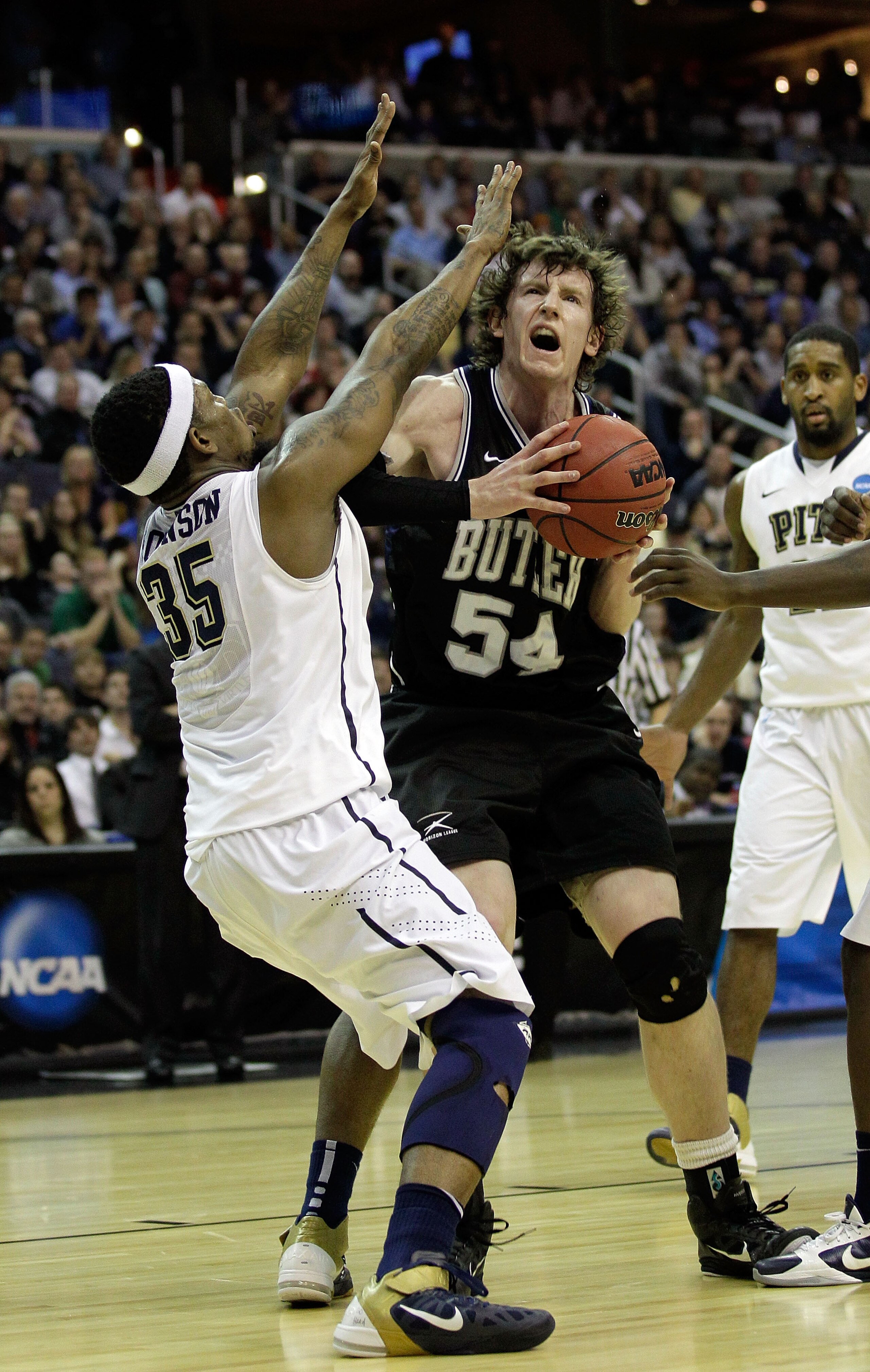 WASHINGTON - MARCH 19:  Matt Howard #54 of the Butler Bulldogs tries to put a shot over Nasir Robinson #35 of the Pittsburgh Panthers during the third round of the 2011 NCAA men's basketball tournament at Verizon Center on March 19, 2011 in Washington, DC