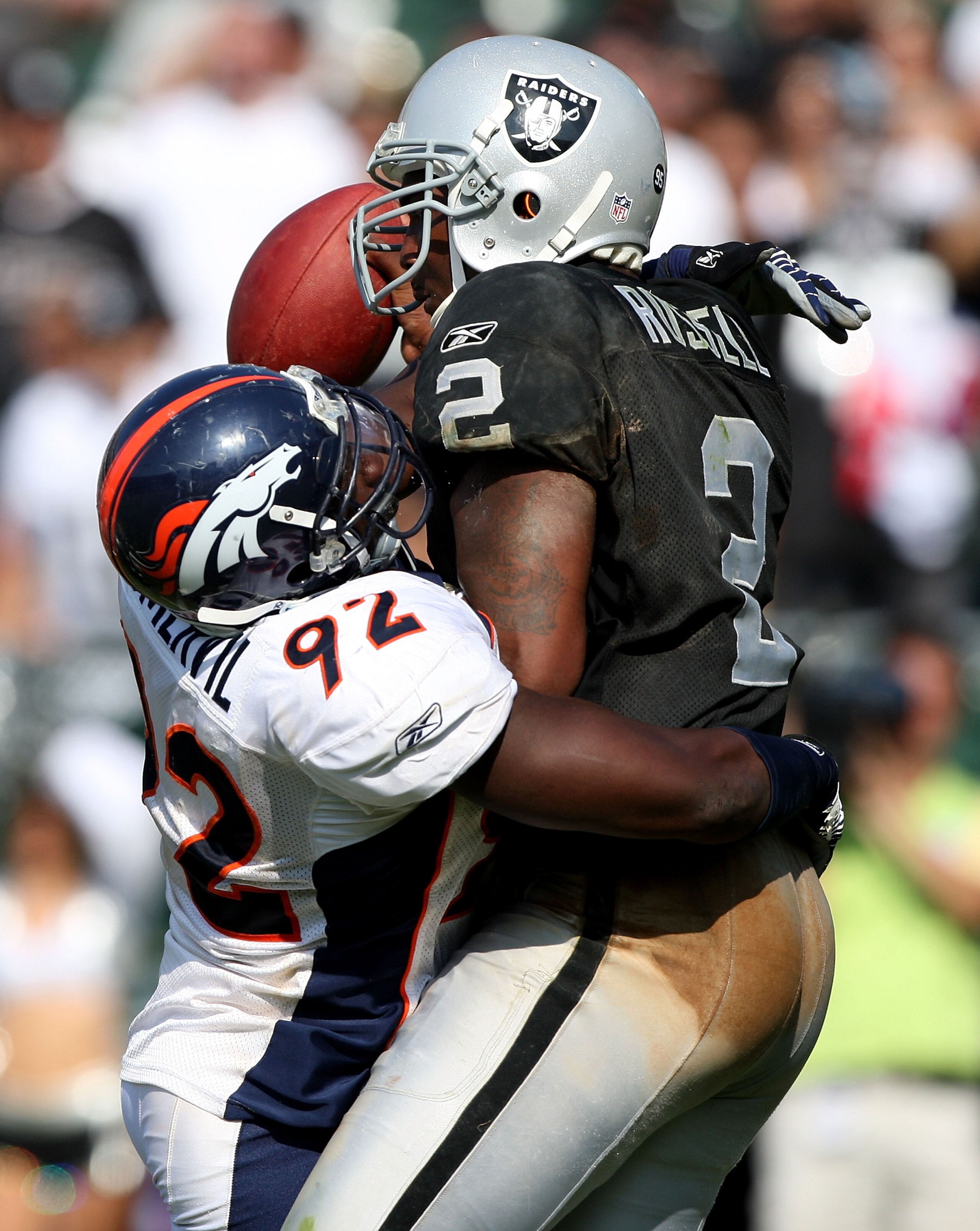 OAKLAND, CA - SEPTEMBER 27:  JaMarcus Russell #2 of the Oakland Raiders is sacked by Elvis Dumervil #92 of the Denver Broncos on September 27, 2009 during an NFL game at the Oakland-Alameda County Coliseum in Oakland, California.  (Photo by Jed Jacobsohn/