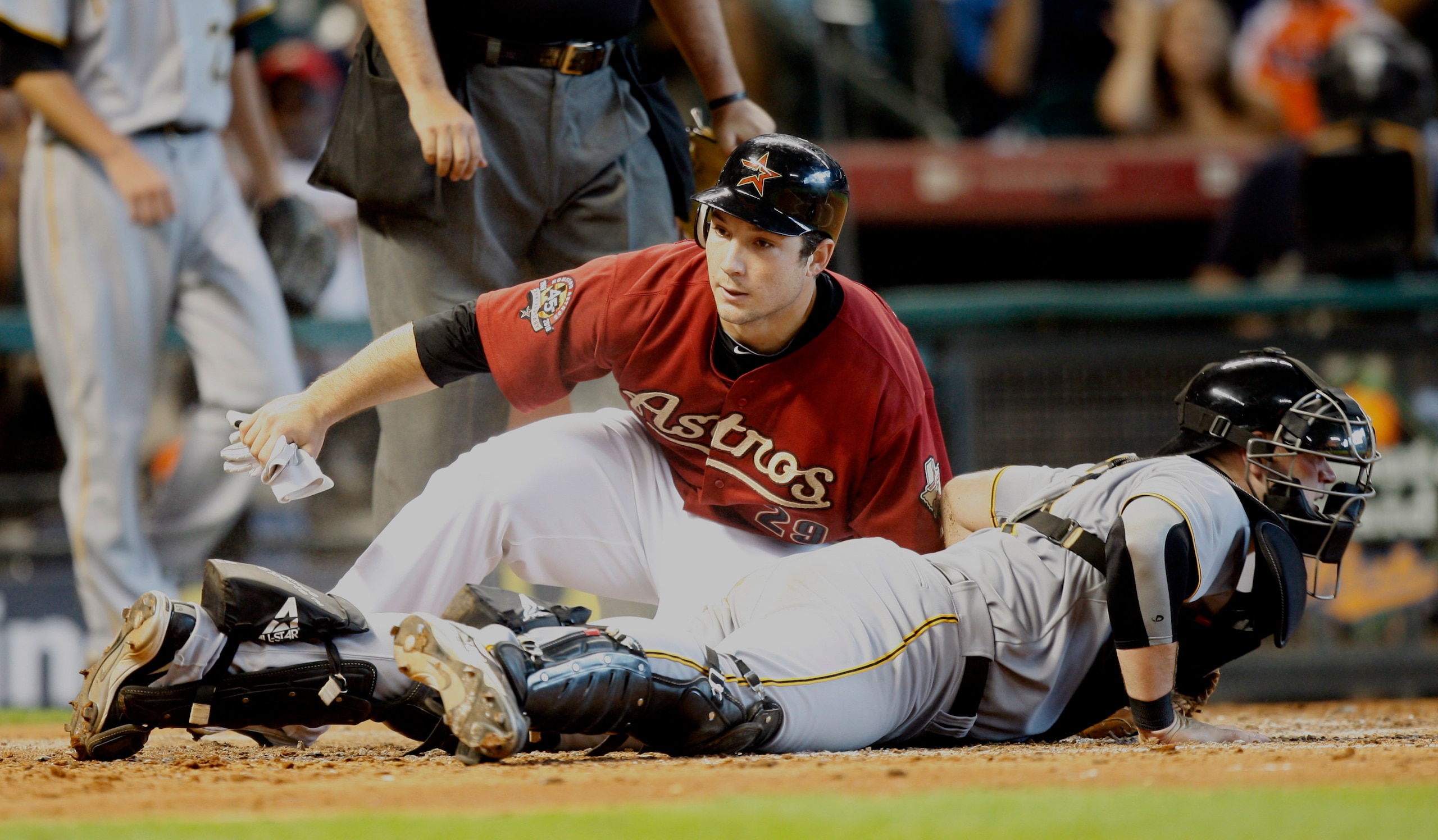HOUSTON - AUGUST 15:  Brett Wallace #29 of the Houston Astros slides safely into home plate as catcher Chris Snyder #19 of the Pittsburgh Pirates looks around at Minute Maid Park on August 15, 2010 in Houston, Texas.  (Photo by Bob Levey/Getty Images)