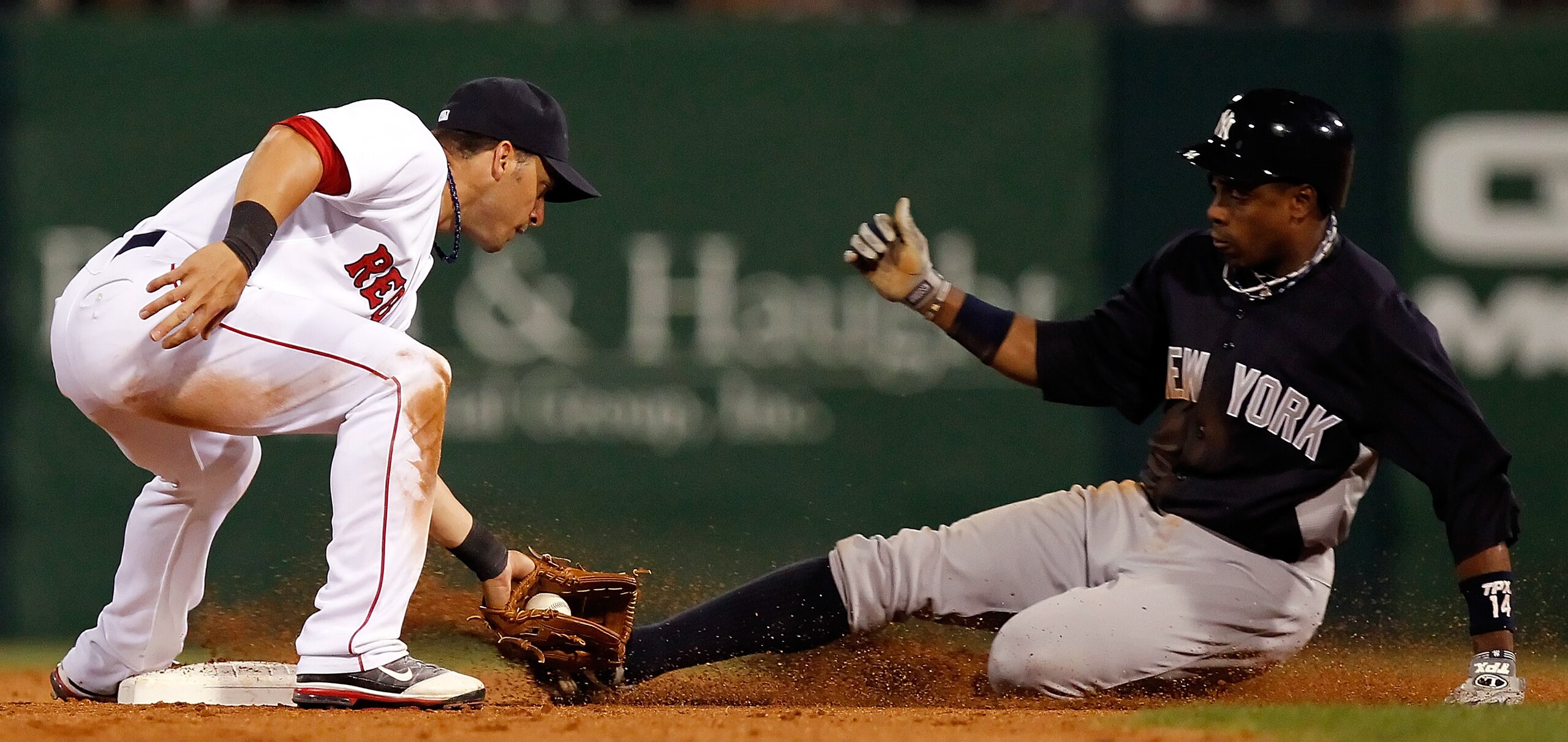 FORT MYERS, FL - MARCH 14:  Shortstop Marco Scutaro #16 of the Boston Red Sox tags out outfielder Curtis Granderson #14 of the New York Yankees as he attempts a steal during a Grapefruit League Spring Training Game at City of Palms Park on March 14, 2011