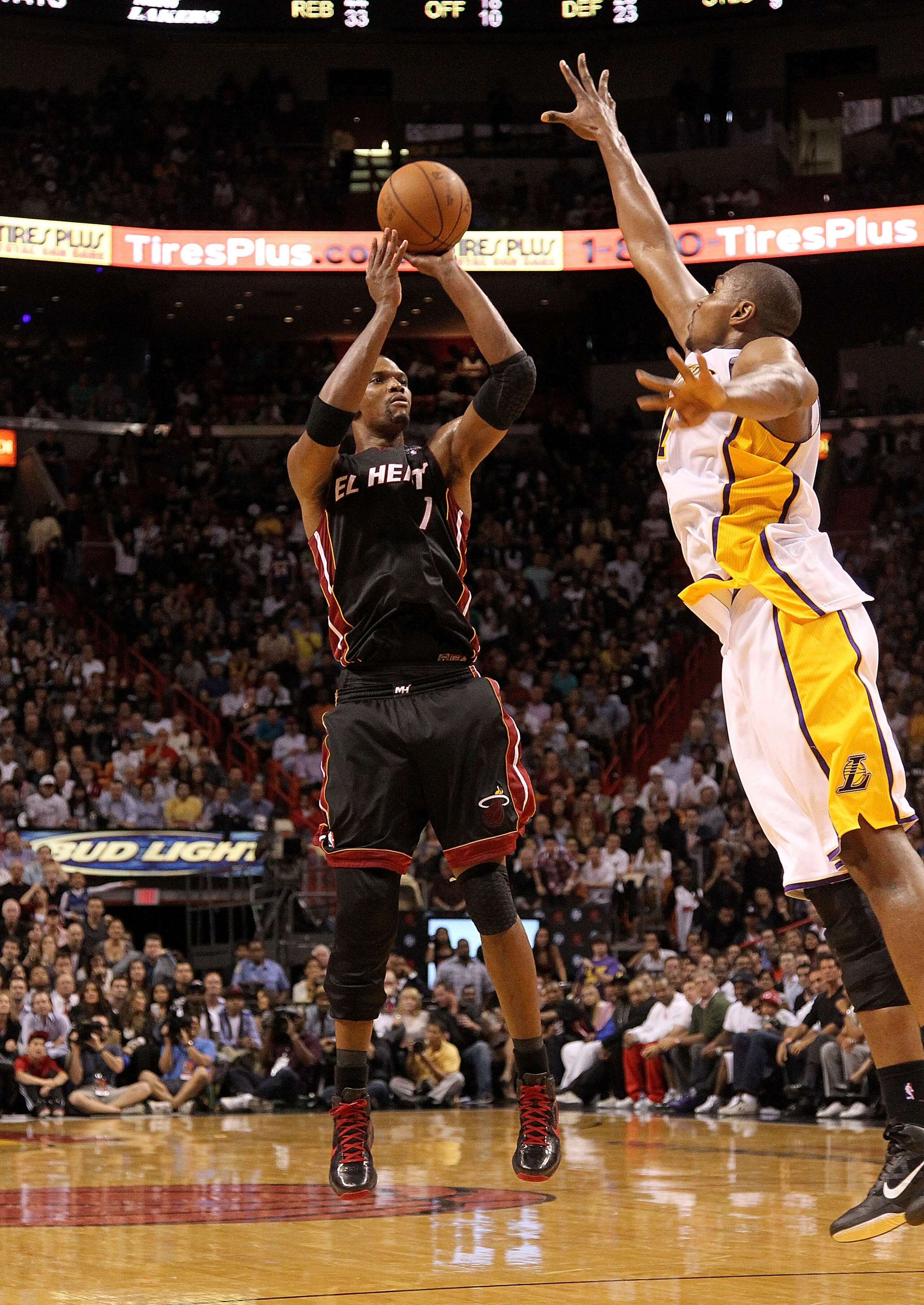 MIAMI, FL - MARCH 10: Chris Bosh #1 of the Miami Heat shoots over Andrew Bynum #17 of the Los Angeles Lakers during a game at American Airlines Arena on March 10, 2011 in Miami, Florida. NOTE TO USER: User expressly acknowledges and agrees that, by dow MIAMI, FL - MARCH 10: Chris Bosh #1 of the Miami Heat shoots over Andrew Bynum #17 of the Los Angeles Lakers during a game at American Airlines Arena on March 10, 2011 in Miami, Florida. NOTE TO USER: User expressly acknowledges and agrees that, by dow