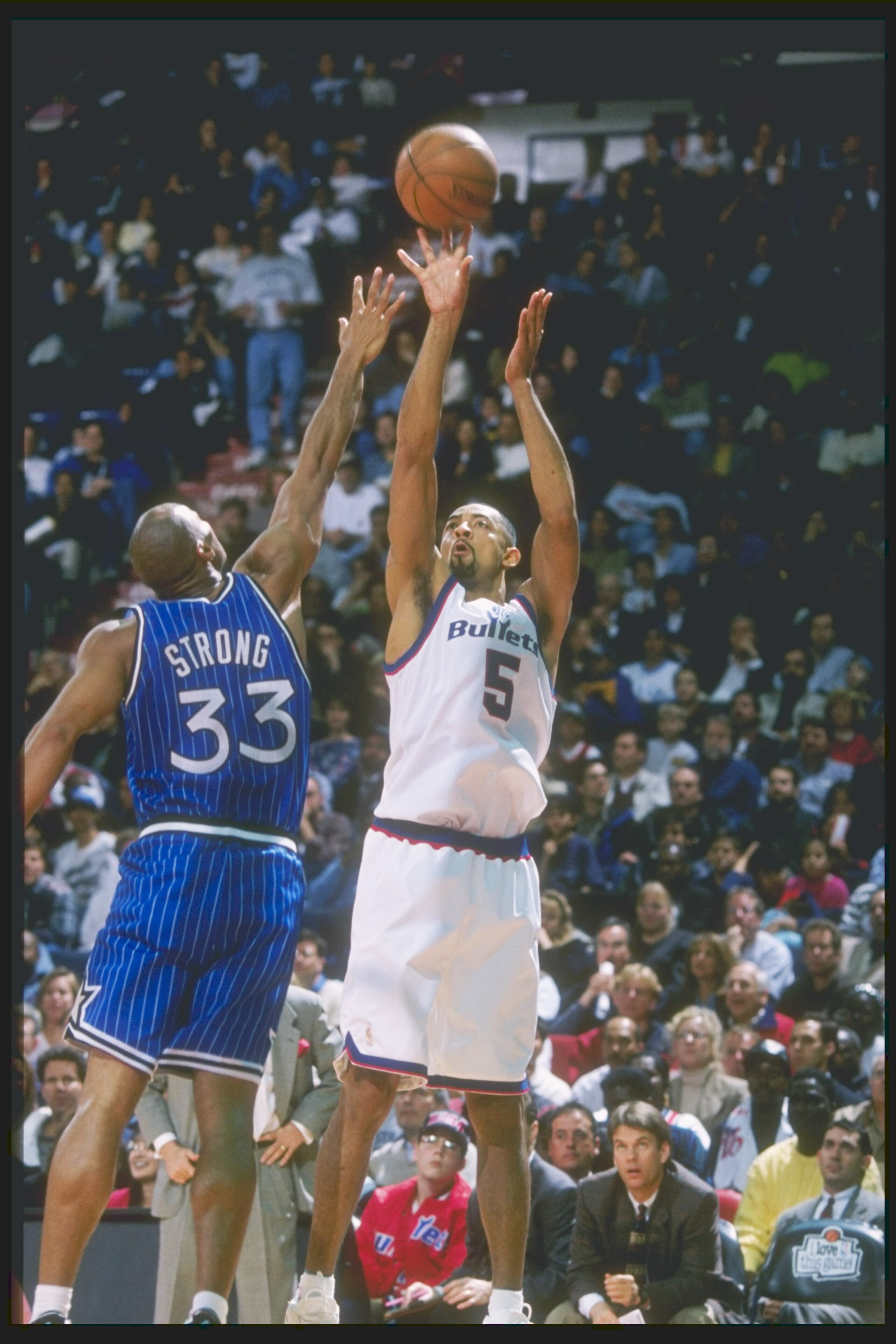 18 Apr 1997: Forward Juwan Howard of the Washington Bullets shoots the ball over forward Derek Strong of the Orlando Magic at the US Air Arena in Landover, Maryland. The Bullets won the game 104-93.