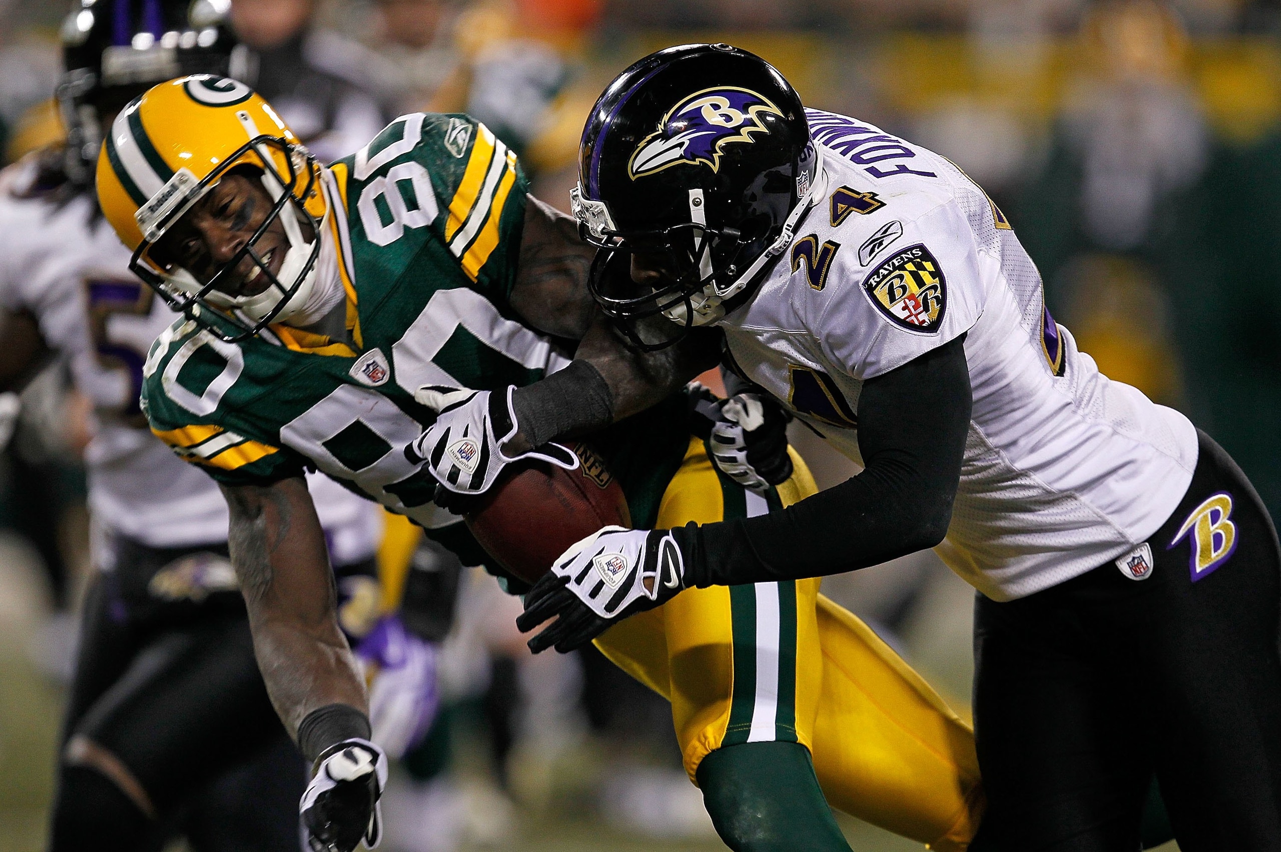 GREEN BAY, WI - DECEMBER 07: Domonique Foxworth #24 of the Baltimore Ravens hits Donald Driver #80 of the Green Bay Packers at Lambeau Field on December 7, 2009 in Green Bay, Wisconsin. The Packers defeated the Ravens 27-17. (Photo by Jonathan Daniel/Gett