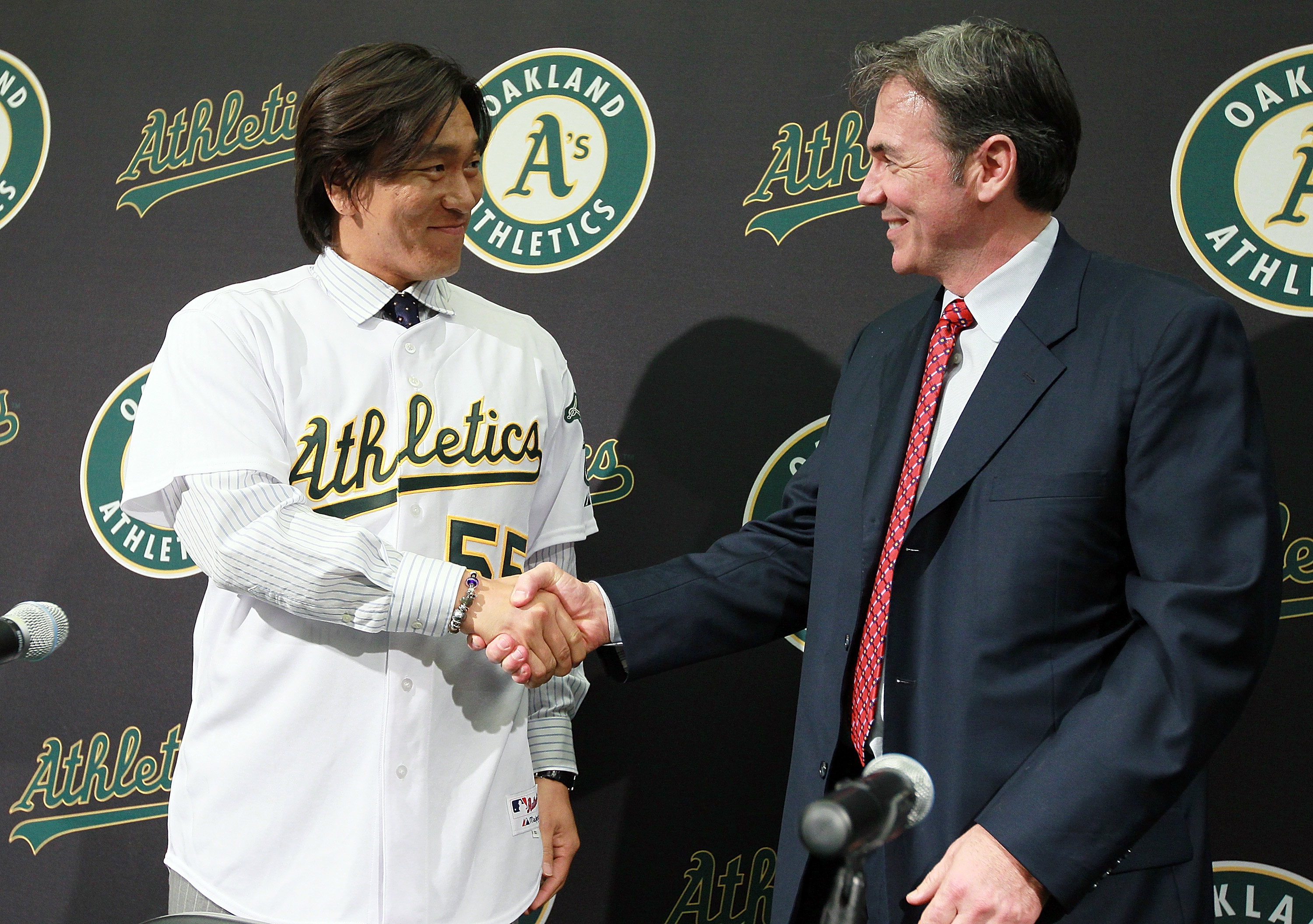 OAKLAND, CA - DECEMBER 14:  Hideki Matsui (L) shakes hands with Oakland Athletics general manager Billy Beane (R) after trying on his new jersey during a press conference where he was introduced as the newest member of the Oakland Athletics at Oakland-Ala
