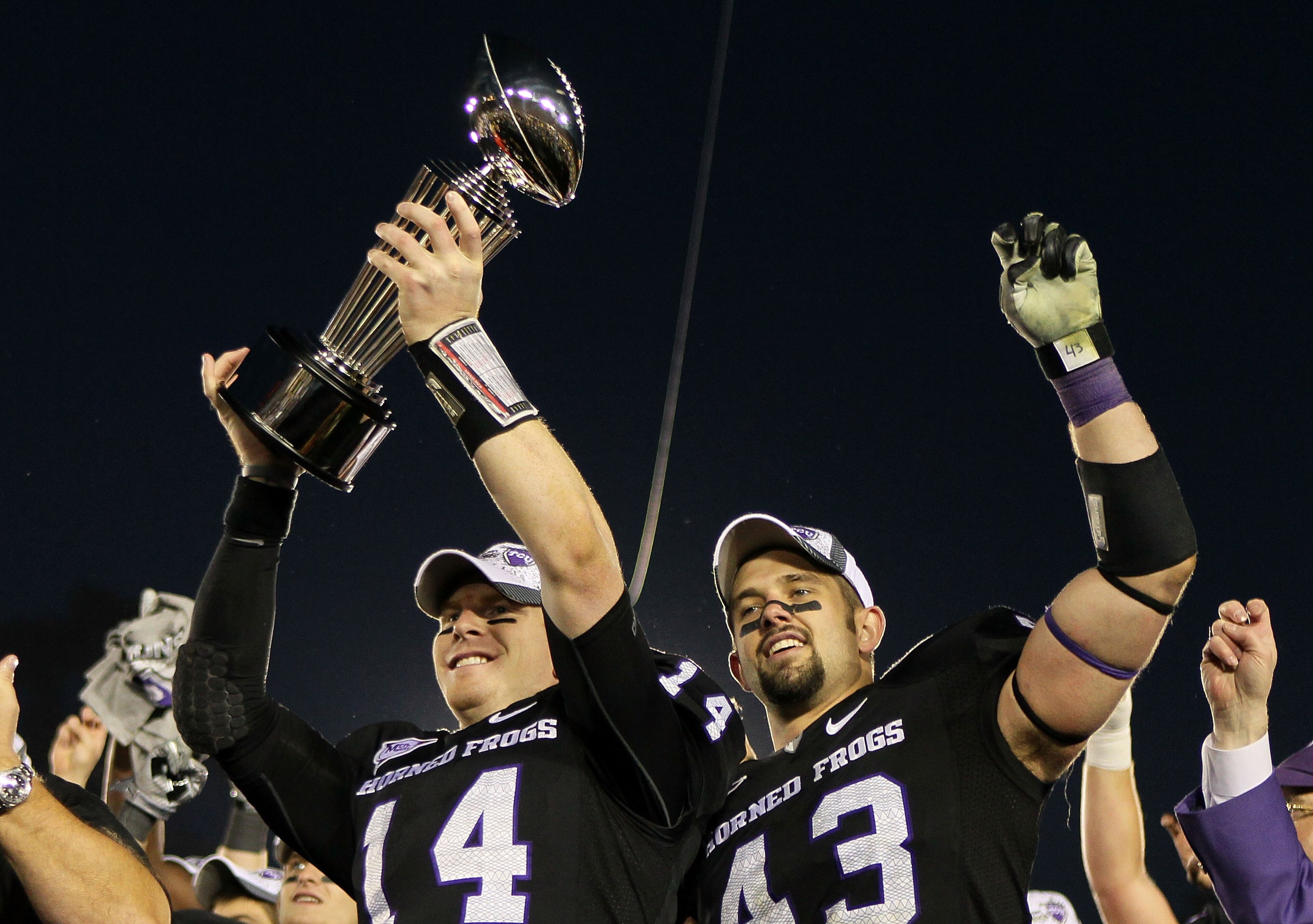 PASADENA, CA - JANUARY 01: Quarterback Andy Dalton #14 and linebacker Tank Carder #43 of the TCU Horned Frogs celebrate with the Rose Bowl Championship Trophy after defeating the Wisconsin Badgers 21-19 in the 97th Rose Bowl game on January 1, 2011 in Pa PASADENA, CA - JANUARY 01: Quarterback Andy Dalton #14 and linebacker Tank Carder #43 of the TCU Horned Frogs celebrate with the Rose Bowl Championship Trophy after defeating the Wisconsin Badgers 21-19 in the 97th Rose Bowl game on January 1, 2011 in Pa