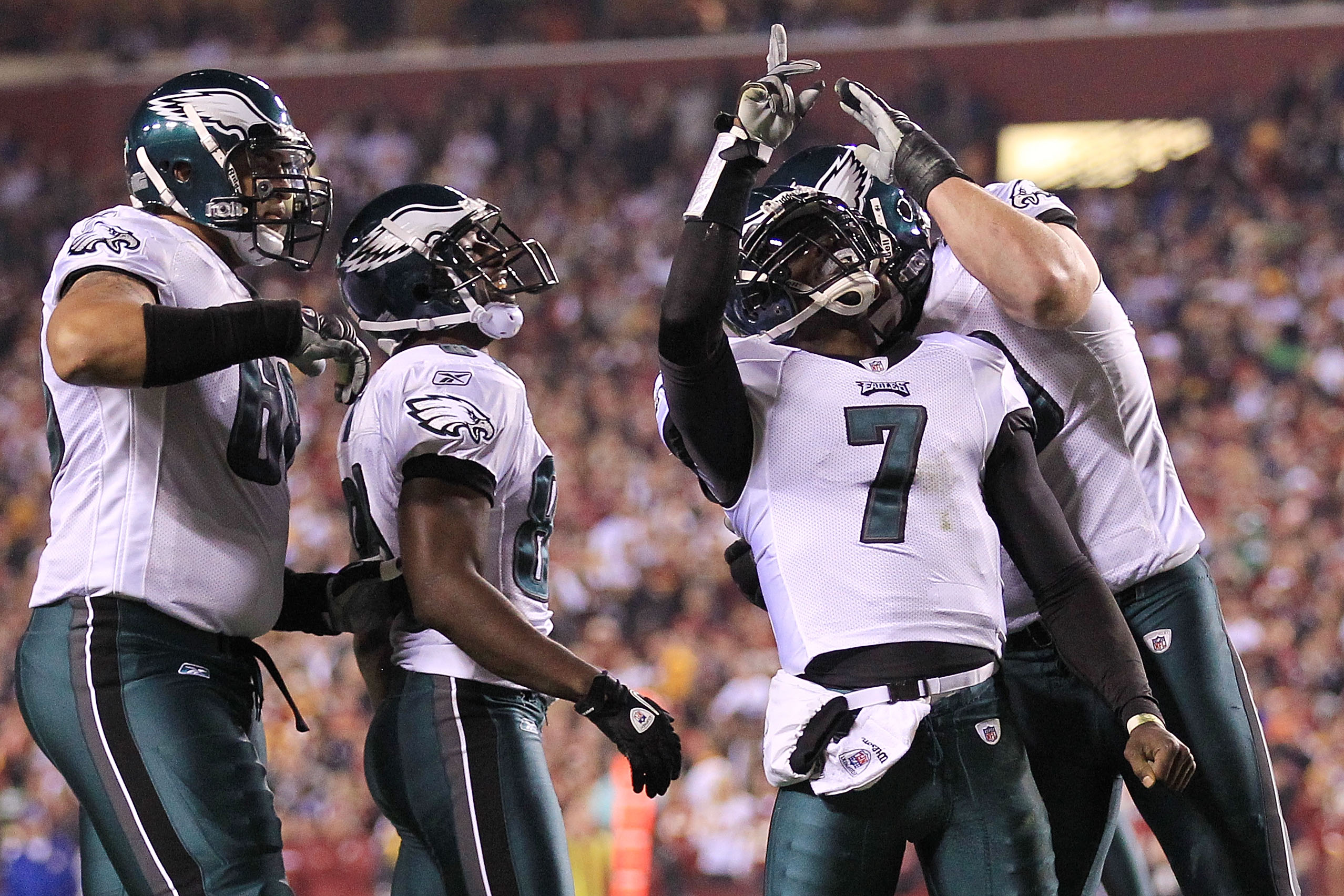 LANDOVER, MD - NOVEMBER 15: Michael Vick #7 of the Philadelphia Eagles is congratulated by team mate Todd Herremans #79 after scoring a touchdown against the Washington Redskins on November 15, 2010 at FedExField in Landover, Maryland. (Photo by Chris Mc