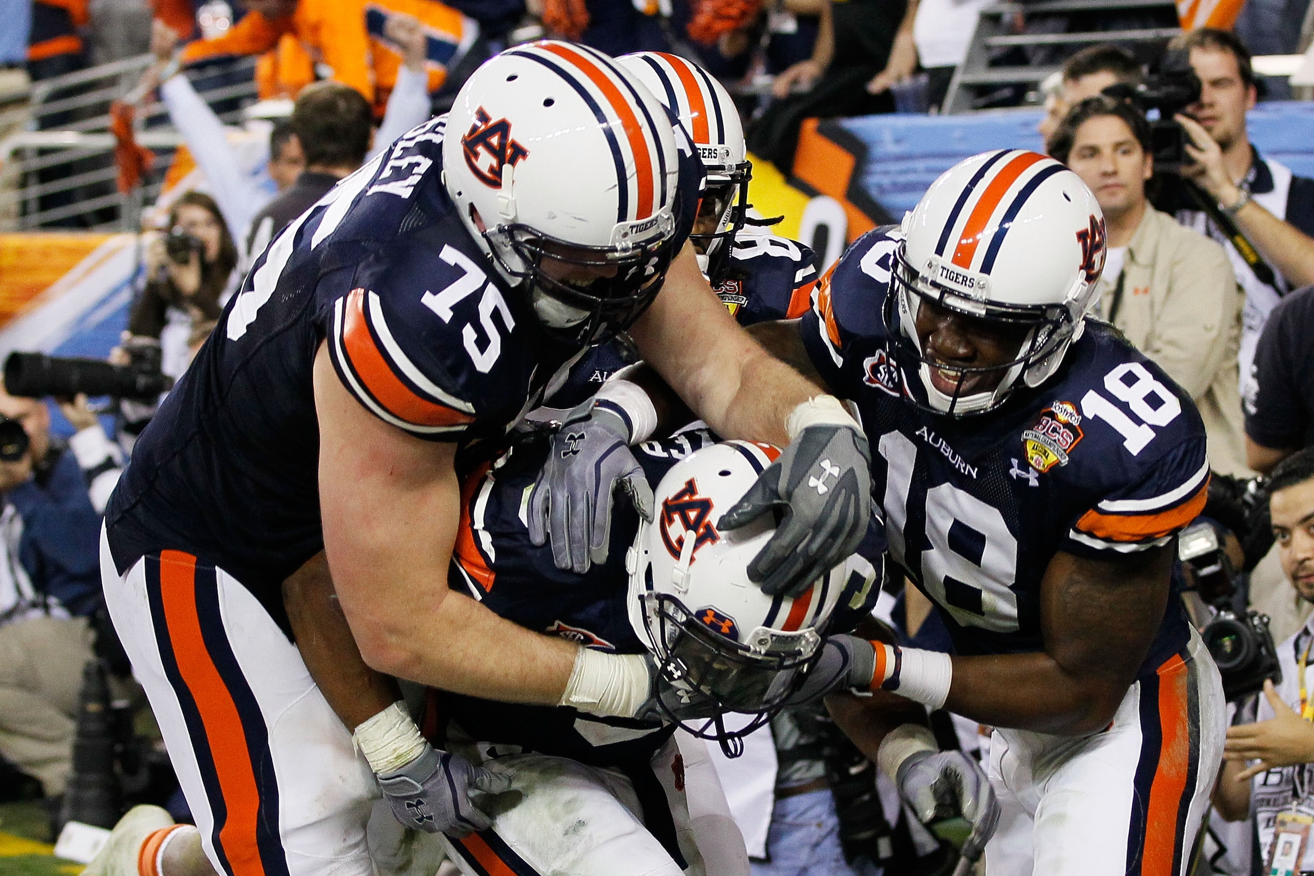 GLENDALE, AZ - JANUARY 10:  (C) Michael Dyer #5 of the Auburn Tigers celebrates with teammates Brandon Mosley #75 and Kodi Burns #18 after he ran the ball for 16-yards and is called down at the one-yardline with 10 seconds remaining in the fourth quarter
