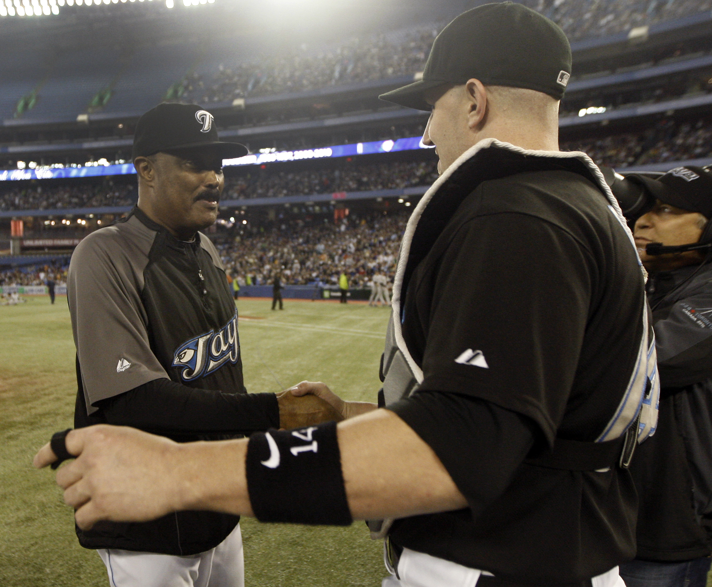 TORONTO, ON - SEPTEMBER 29:  Manager Cito Gaston takes his final walk and shakes hands with John Buck #14 on home field after the Toronto Blue Jays defeated the the New York Yankees 8-4 during a MLB game at the Rogers Centre September 29, 2010 in Toronto,