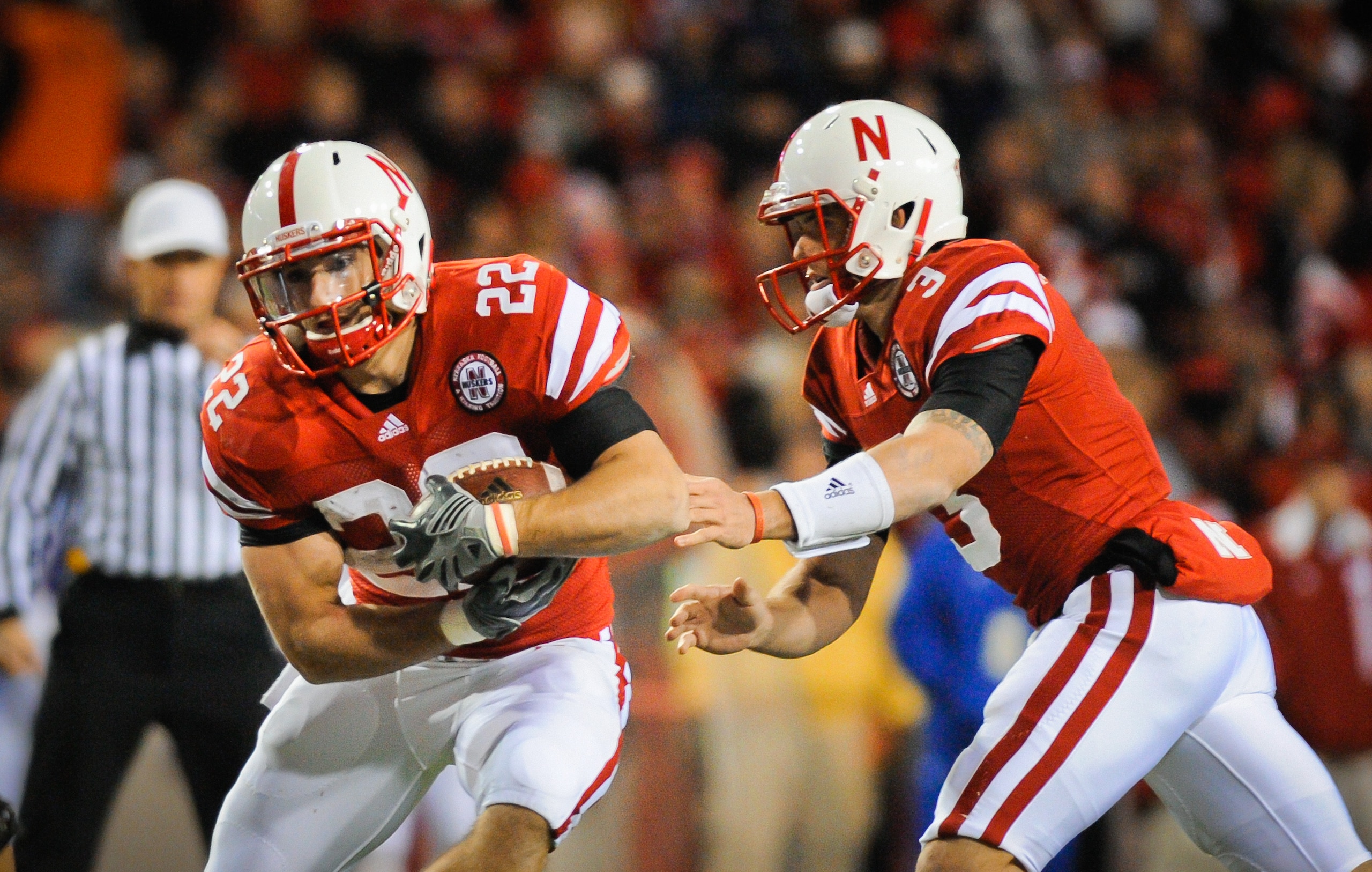 LINCOLN, NE - NOVEMBER 13: Taylor Martinez #3 of the Nebraska Cornhuskers hands the ball to Rex Burkhead #22 during second half action of their game at Memorial Stadium on November 13, 2010 in Lincoln, Nebraska. Nebraska Defeated Kansas 20-3. (Photo by Er