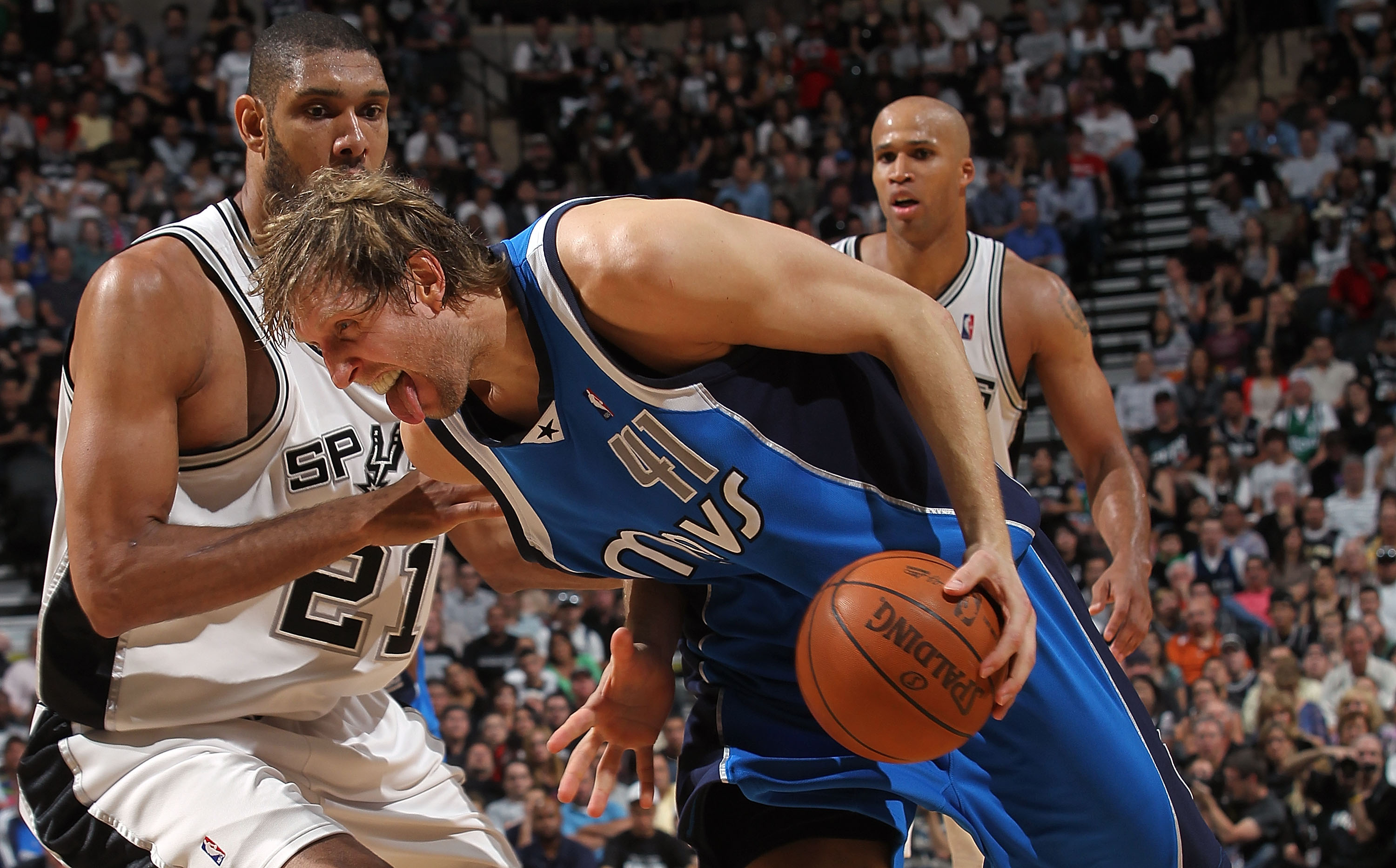 SAN ANTONIO - APRIL 25:  Forward Dirk Nowitzki #41 of the Dallas Mavericks dribbles the ball past Tim Duncan #21 of the San Antonio Spurs in Game Four of the Western Conference Quarterfinals during the 2010 NBA Playoffs at AT&T Center on April 25, 2010 in