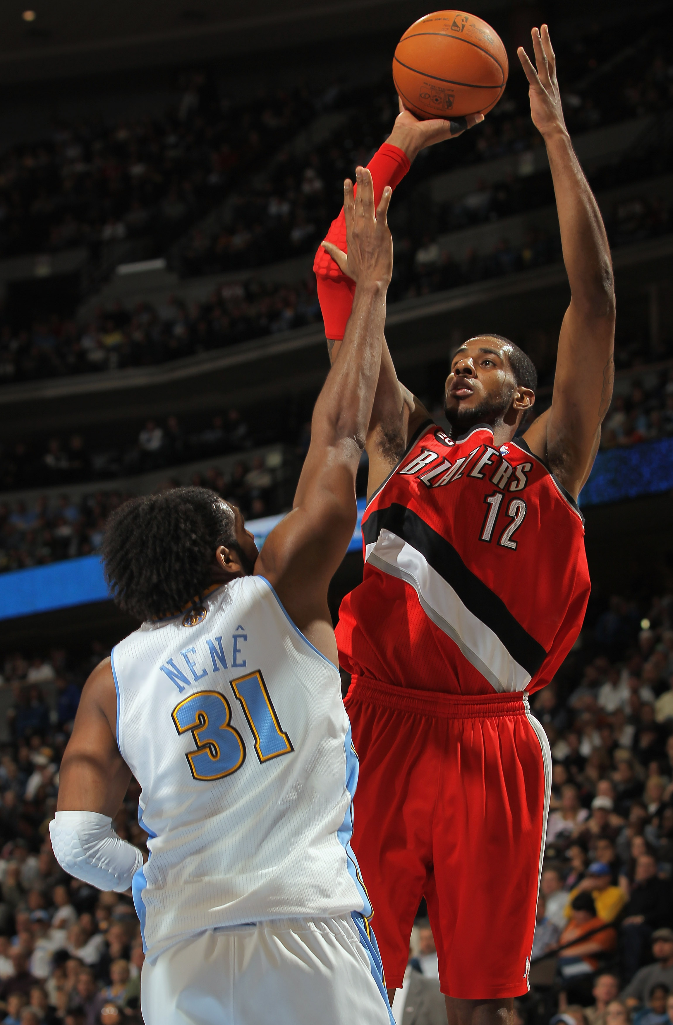 DENVER - DECEMBER 28:  LaMarcus Aldridge #12 of the Portland Trail Blazers takes a shot over Nene #31 of the Denver Nuggets at Pepsi Center on December 28, 2010 in Denver, Colorado. NOTE TO USER: User expressly acknowledges and agrees that, by downloading