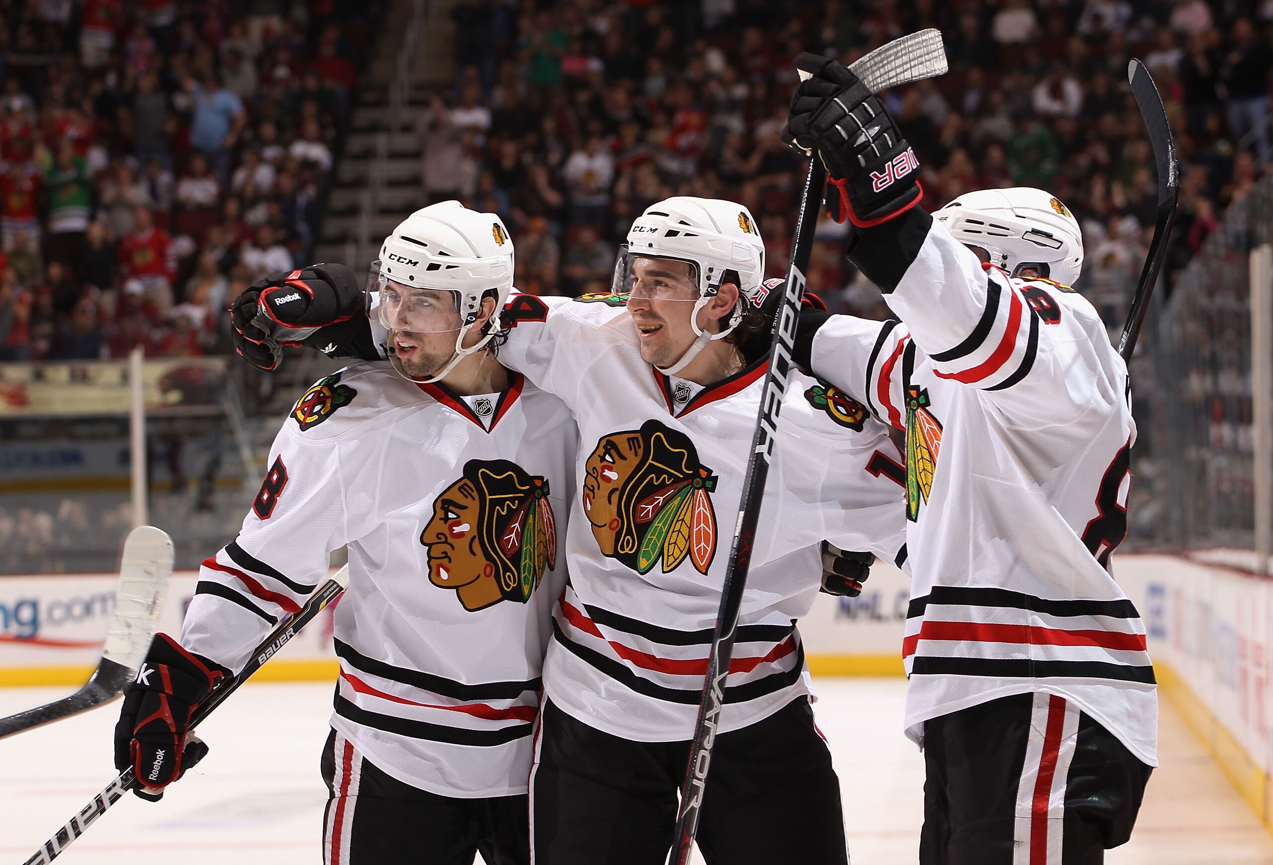 GLENDALE, AZ - MARCH 20:  (L-R) Nick Leddy #8, Chris Campoli #14 and Patrick Kane #88 of the Chicago Blackhawks celebrate after Campoli scored a thrid period goal against the Phoenix Coyotes during the NHL game at Jobing.com Arena on March 20, 2011 in Gle