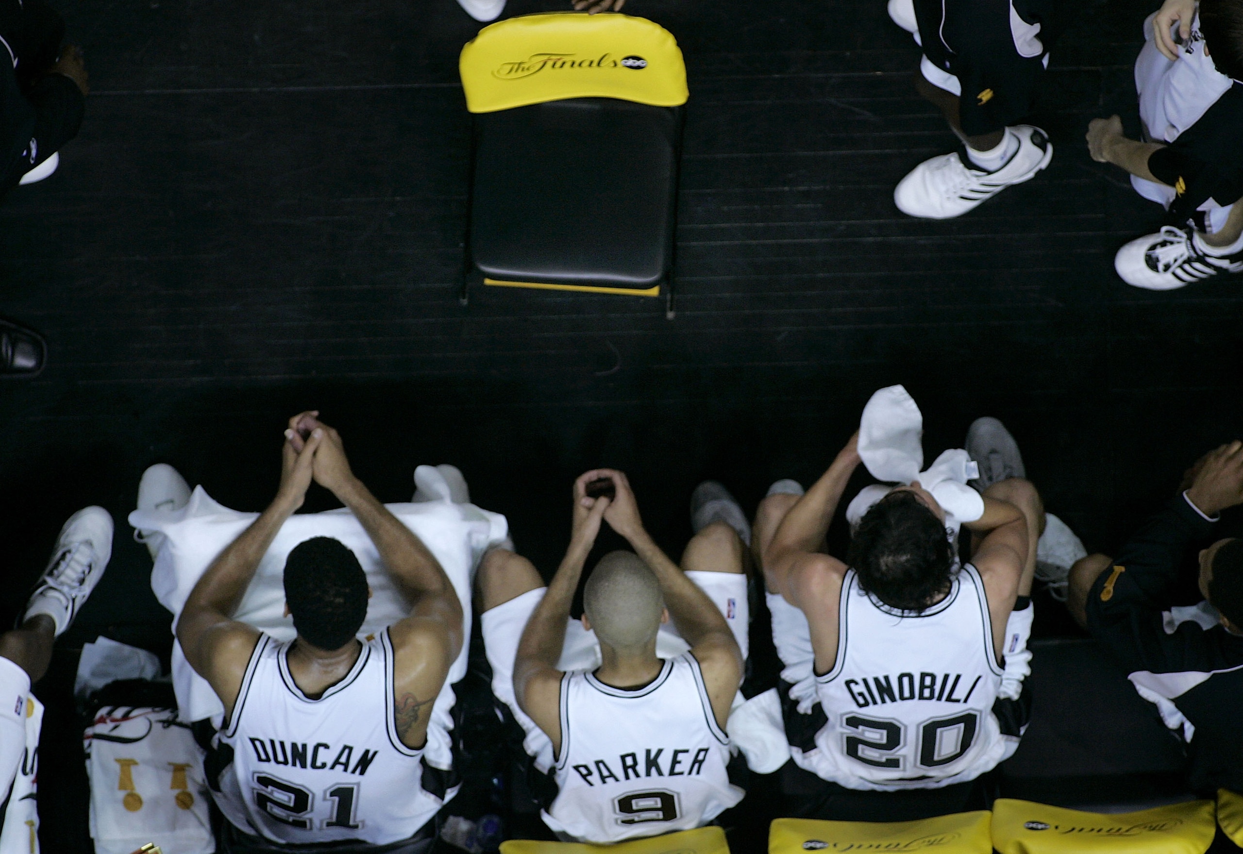 SAN ANTONIO - JUNE 21:  (L-R)  Tim Duncan #21, Tony Parker #9 and Manu Ginobili #20 of the San Antonio Spurs sit on sidelines late in the game during a stoppage in play during Game six of the 2005 NBA Finals at SBC Center on June 21, 2005 in San Antonio,