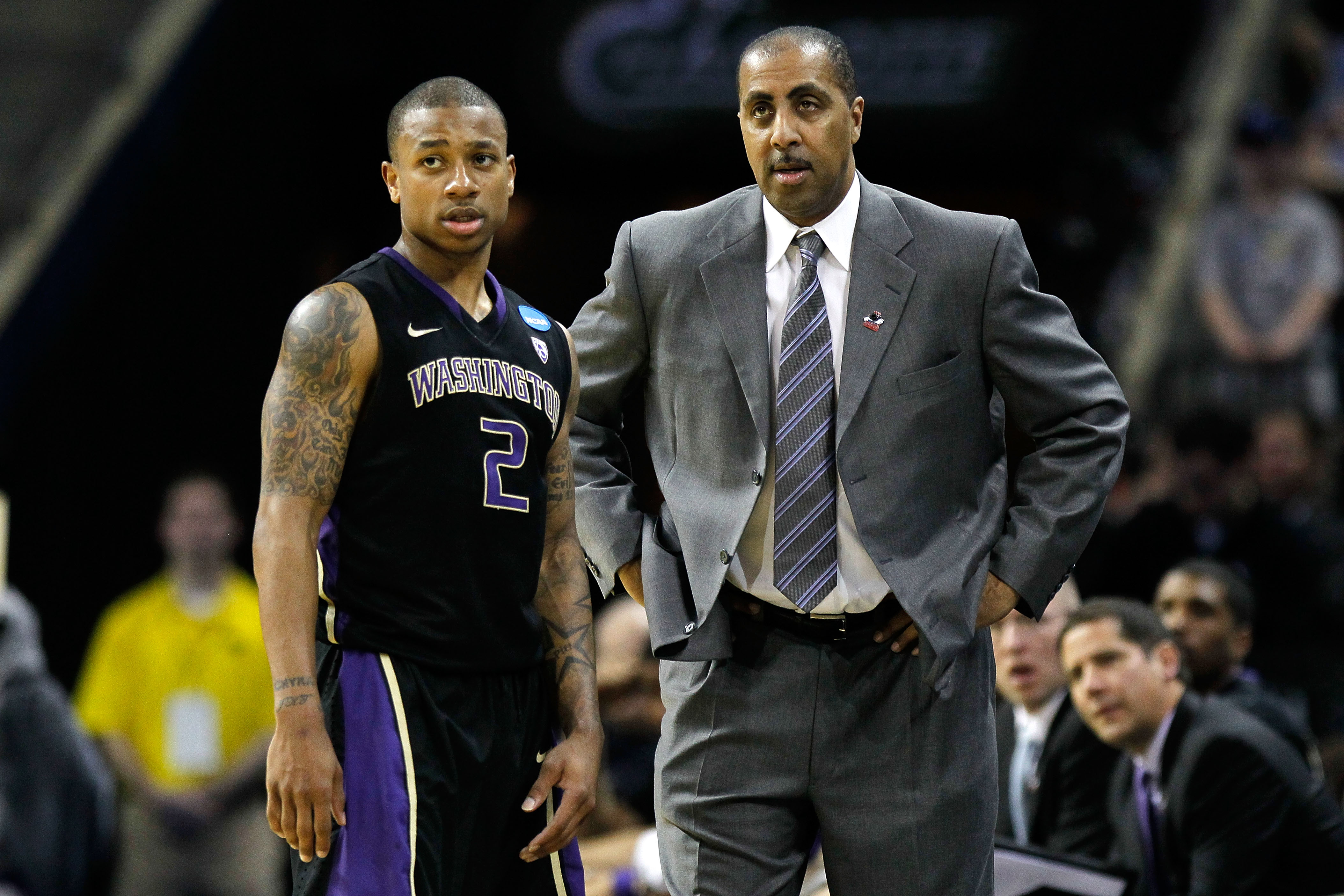 CHARLOTTE, NC - MARCH 20: Isaiah Thomas #2 talks with head coach Lorenzo Romar of the Washington Huskies while taking on the North Carolina Tar Heels during the third round of the 2011 NCAA men's basketball tournament at Time Warner Cable Arena on March