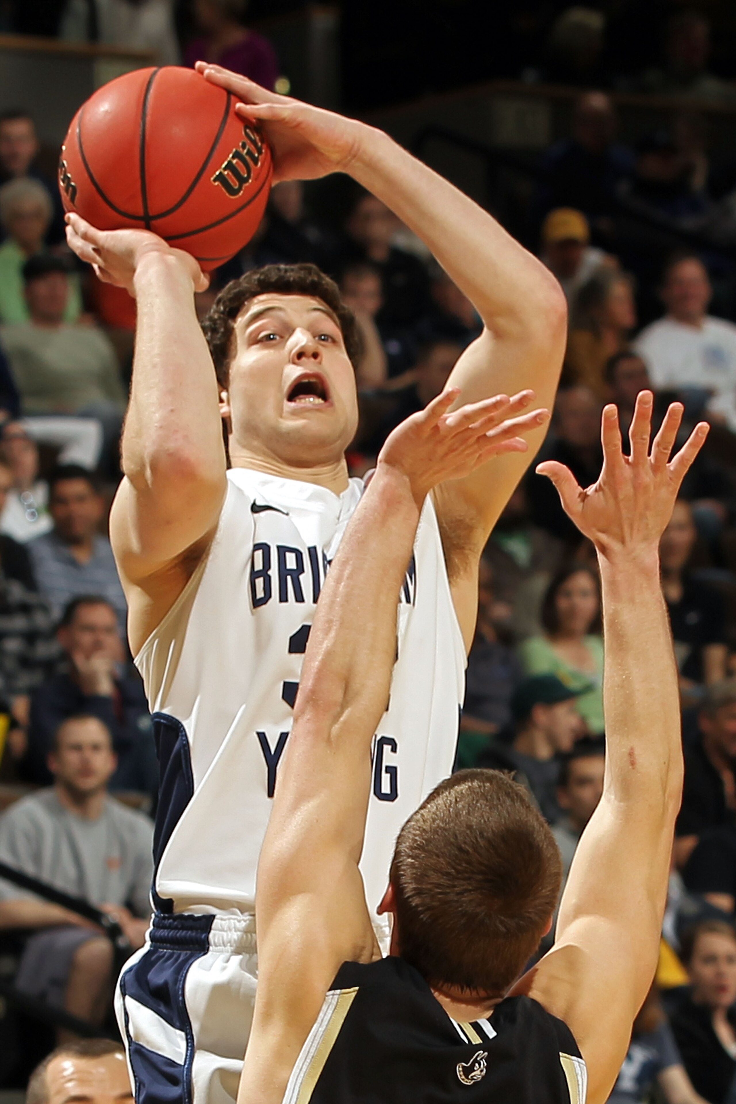 DENVER, CO - MARCH 17: Jimmer Fredette #32 of the Brigham Young Cougars shoots the ball over Brad Loesing #35 of the Wofford Terriers during the second round of the 2011 NCAA men's basketball tournament at Pepsi Center on March 17, 2011 in Denver, Colora DENVER, CO - MARCH 17: Jimmer Fredette #32 of the Brigham Young Cougars shoots the ball over Brad Loesing #35 of the Wofford Terriers during the second round of the 2011 NCAA men's basketball tournament at Pepsi Center on March 17, 2011 in Denver, Colora