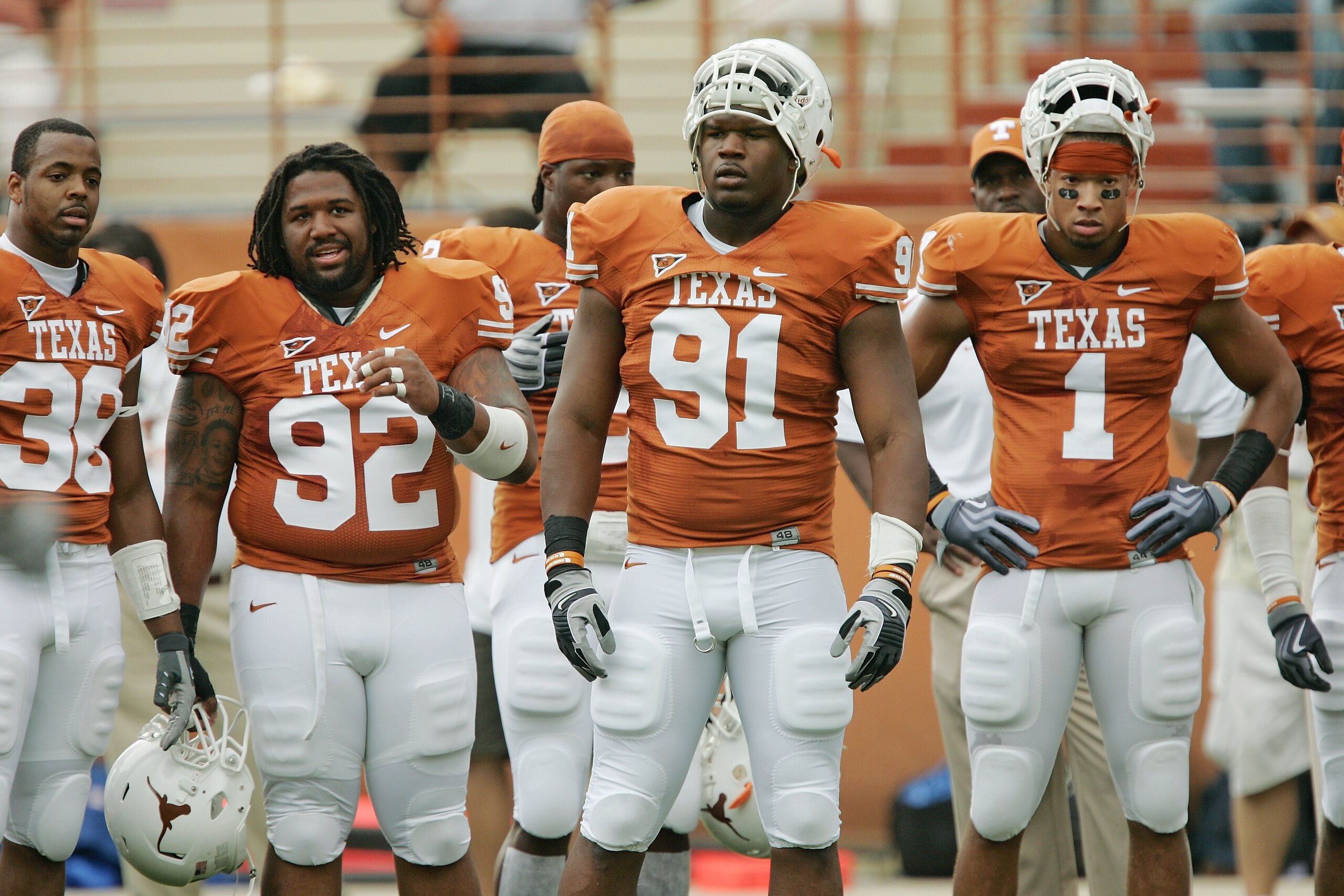 AUSTIN, TX - SEPTEMBER 5:  (L-R) Linebacker Roddrick Muckelroy #38, defensive tackle Ben Alexander #92, defensive tackle Kheeston Randall #91 and linebacker Keenan Robinson #1 of the Texas Longhorns look on from the side line during their game against the