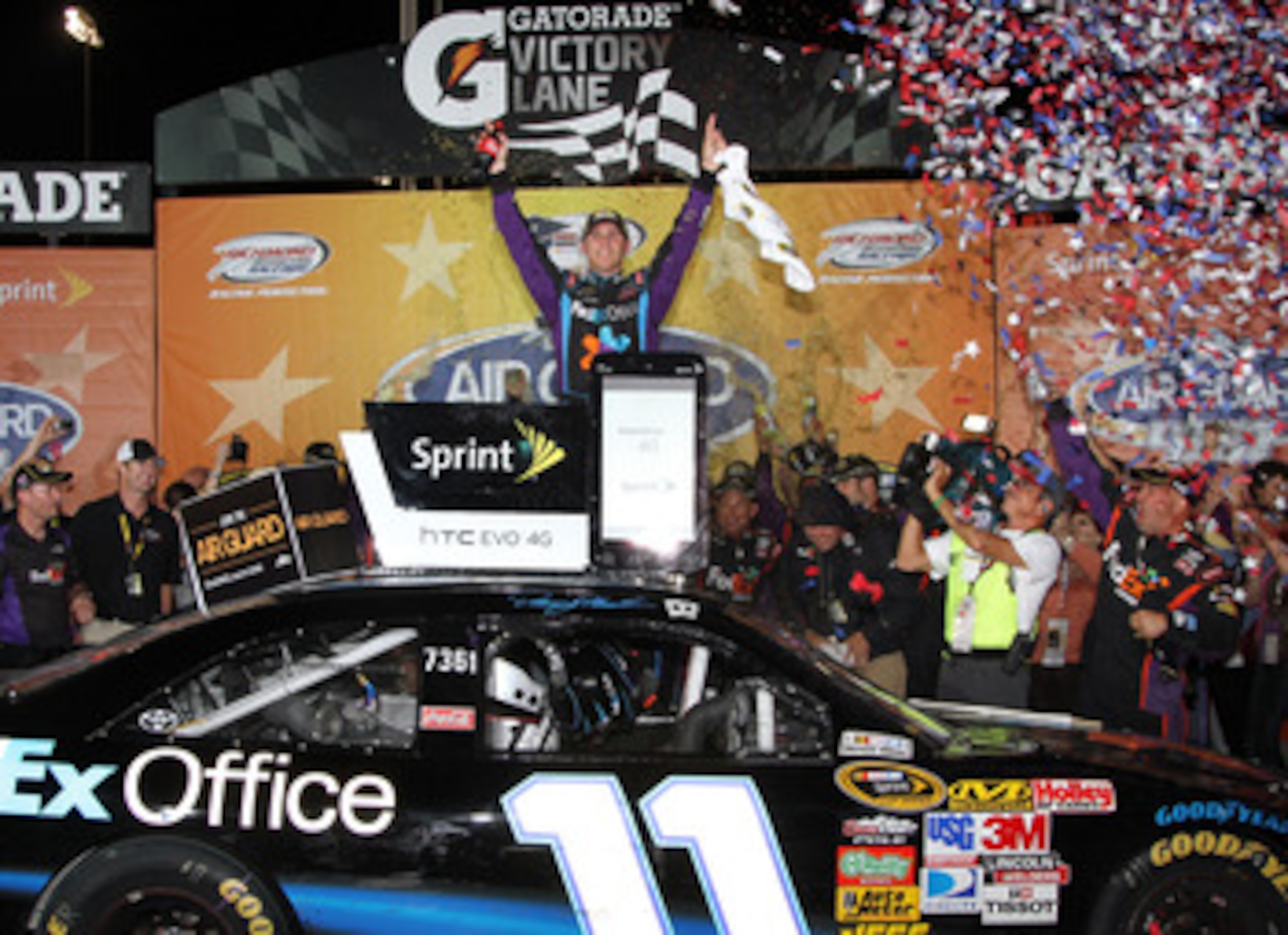 RICHMOND, VA - SEPTEMBER 11:  Denny Hamlin, driver of the #11 FedEx Office Toyota, celebrates in Victory Lane after winning the NASCAR Sprint Cup Series Air Guard 400 at Richmond International Raceway on September 11, 2010 in Richmond, Virginia.  (Photo b