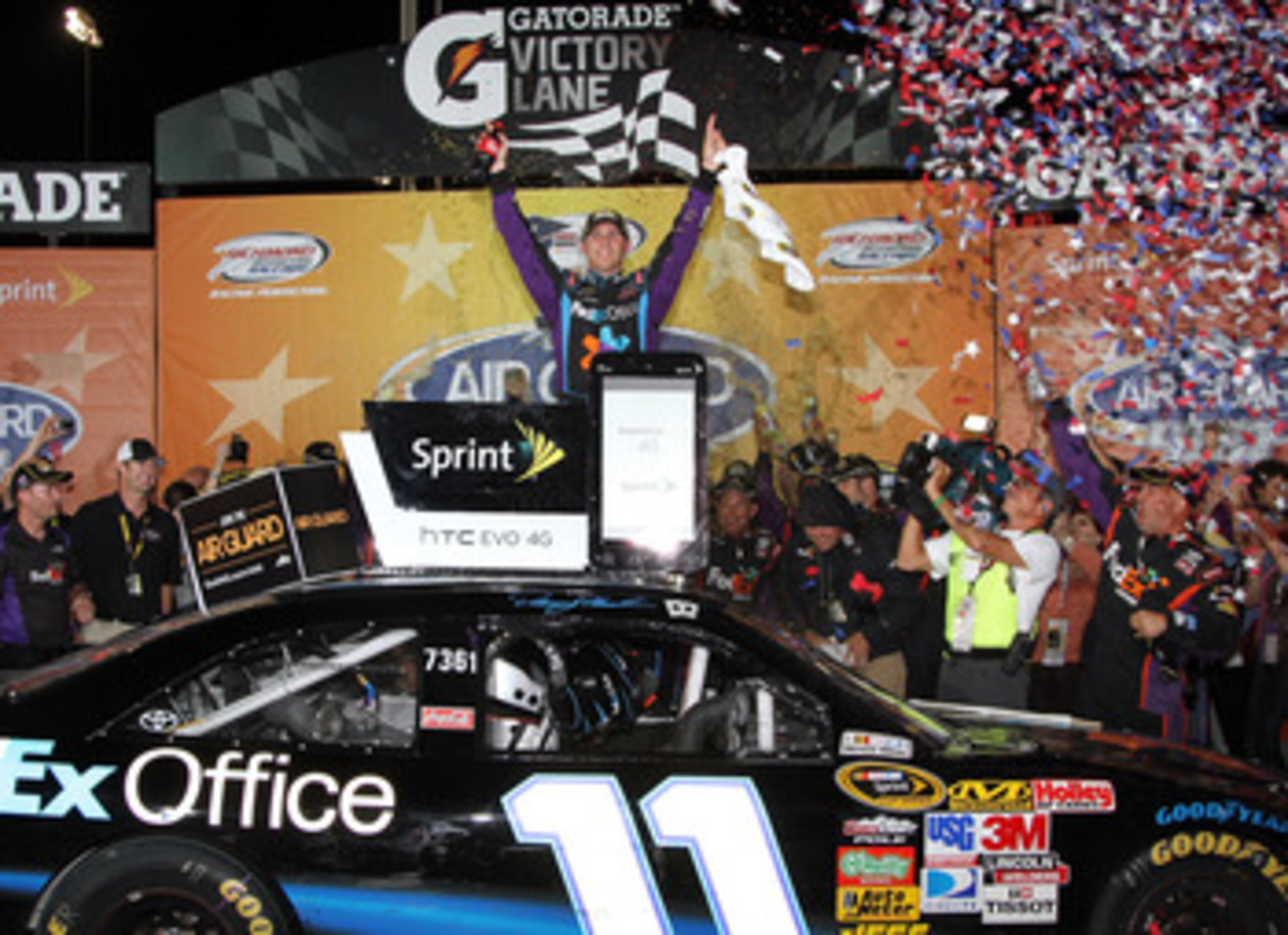 RICHMOND, VA - SEPTEMBER 11:  Denny Hamlin, driver of the #11 FedEx Office Toyota, celebrates in Victory Lane after winning the NASCAR Sprint Cup Series Air Guard 400 at Richmond International Raceway on September 11, 2010 in Richmond, Virginia.  (Photo b