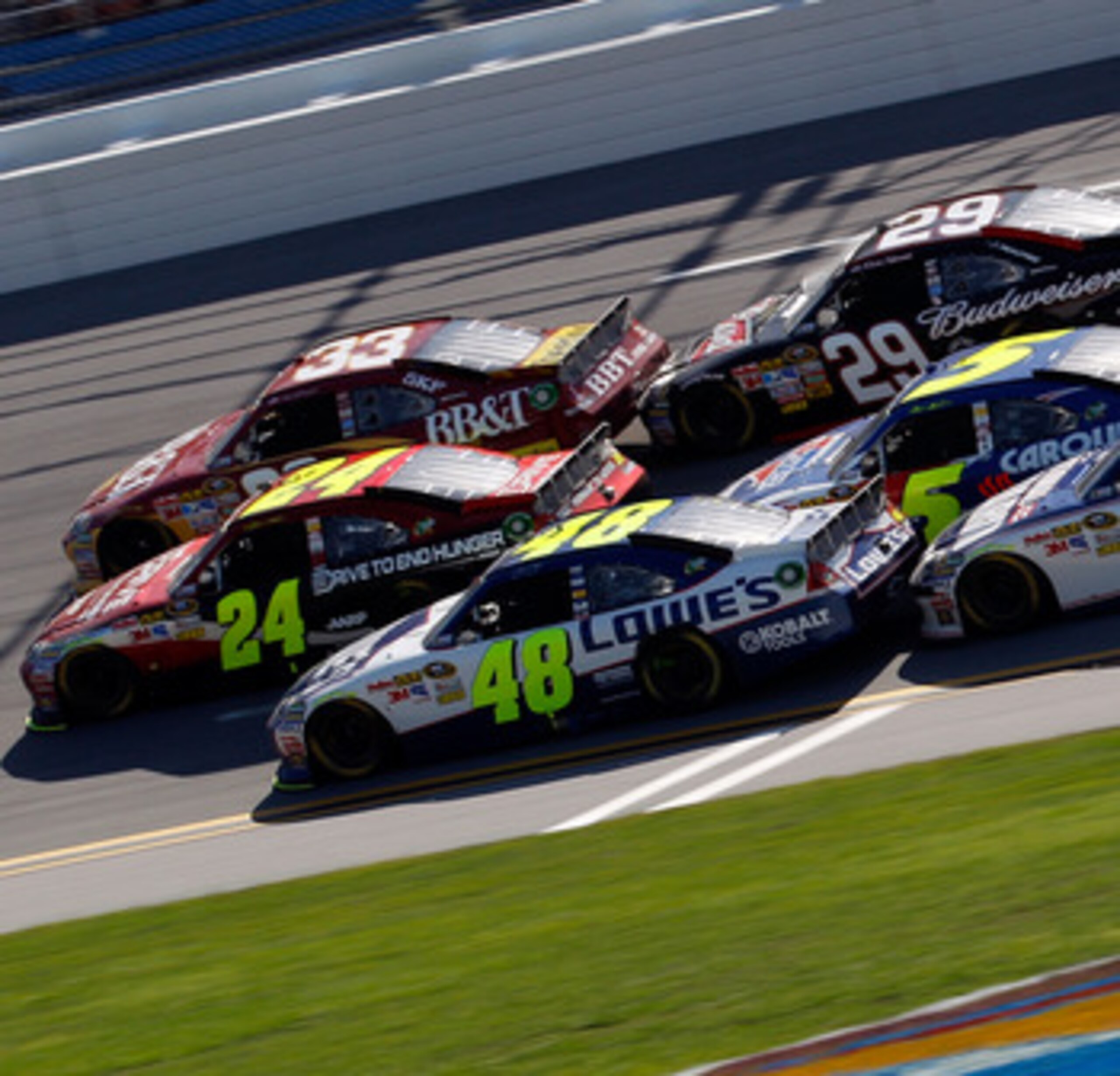 TALLADEGA, AL - APRIL 17:  Clint Bowyer, driver of the #33 BB&T Chevrolet, Jeff Gordon, driver of the #24 Drive to End Hunger/AARP Chevrolet, and Jimmie Johnson, driver of the #48 Lowe's Chevrolet, lead Kevin Harvick, driver of the #29 Budweiser Chevrolet