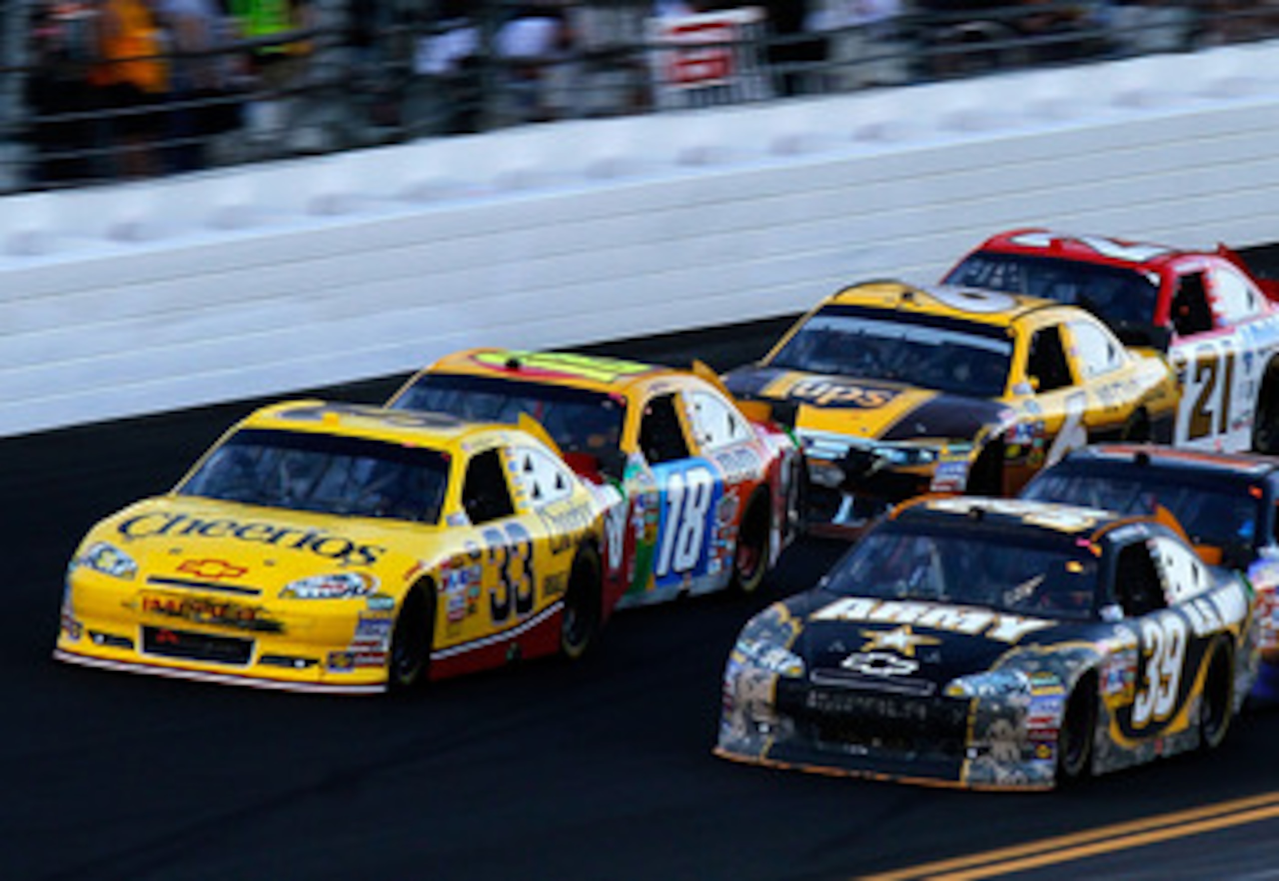 DAYTONA BEACH, FL - FEBRUARY 20:  Clint Bowyer, driver of the #33 Cheerios Chevrolet,  and Ryan Newman, driver of the #39 U.S. Army Chevrolet, lead a group of cars during the NASCAR Sprint Cup Series Daytona 500 at Daytona International Speedway on Februa