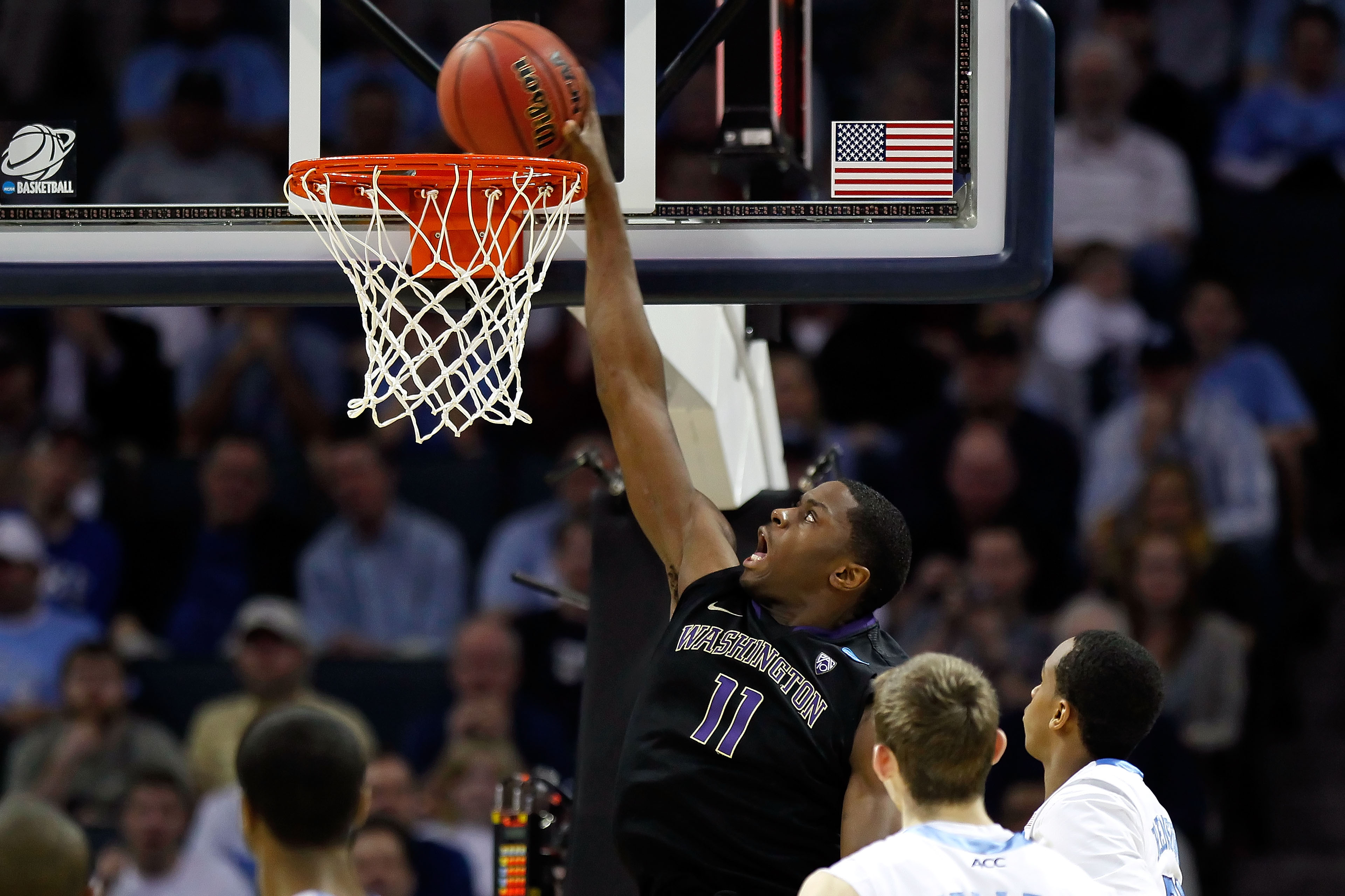 CHARLOTTE, NC - MARCH 20: Matthew Bryan-Amaning #11 of the Washington Huskies dunks the ball in the second half while taking on the North Carolina Tar Heels during the third round of the 2011 NCAA men's basketball tournament at Time Warner Cable Arena on