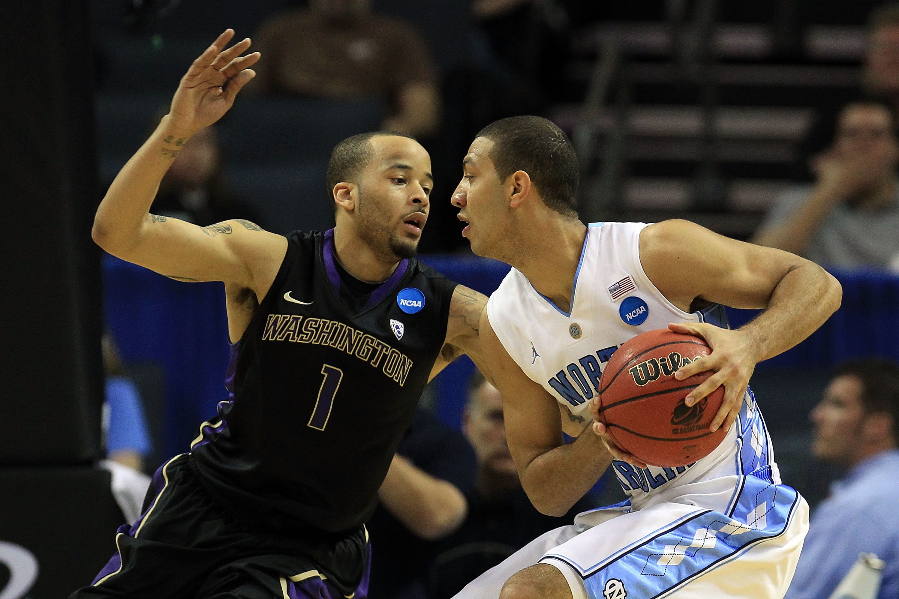 CHARLOTTE, NC - MARCH 20: Kendall Marshall #5 of the North Carolina Tar Heels looks to pass against Venoy Overton #1 of the Washington Huskies during the third round of the 2011 NCAA men's basketball tournament at Time Warner Cable Arena on March 20, 201