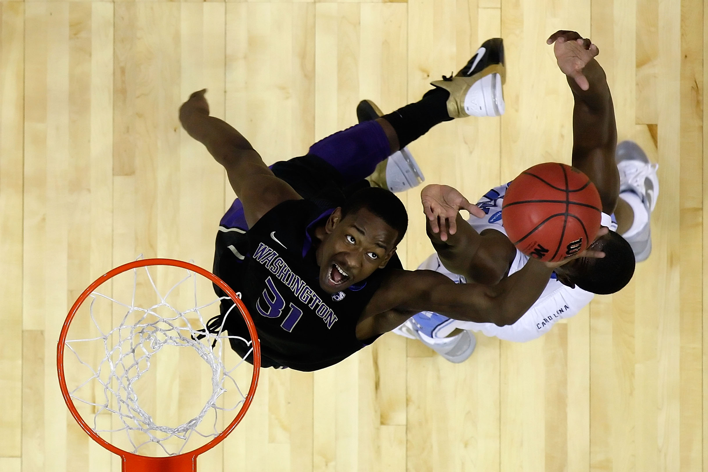 CHARLOTTE, NC - MARCH 20: Terrence Ross #31 of the Washington Huskies and Harrison Barnes #40 of the North Carolina Tar Heels go after a rebound during the third round of the 2011 NCAA men's basketball tournament at Time Warner Cable Arena on March 20, 2