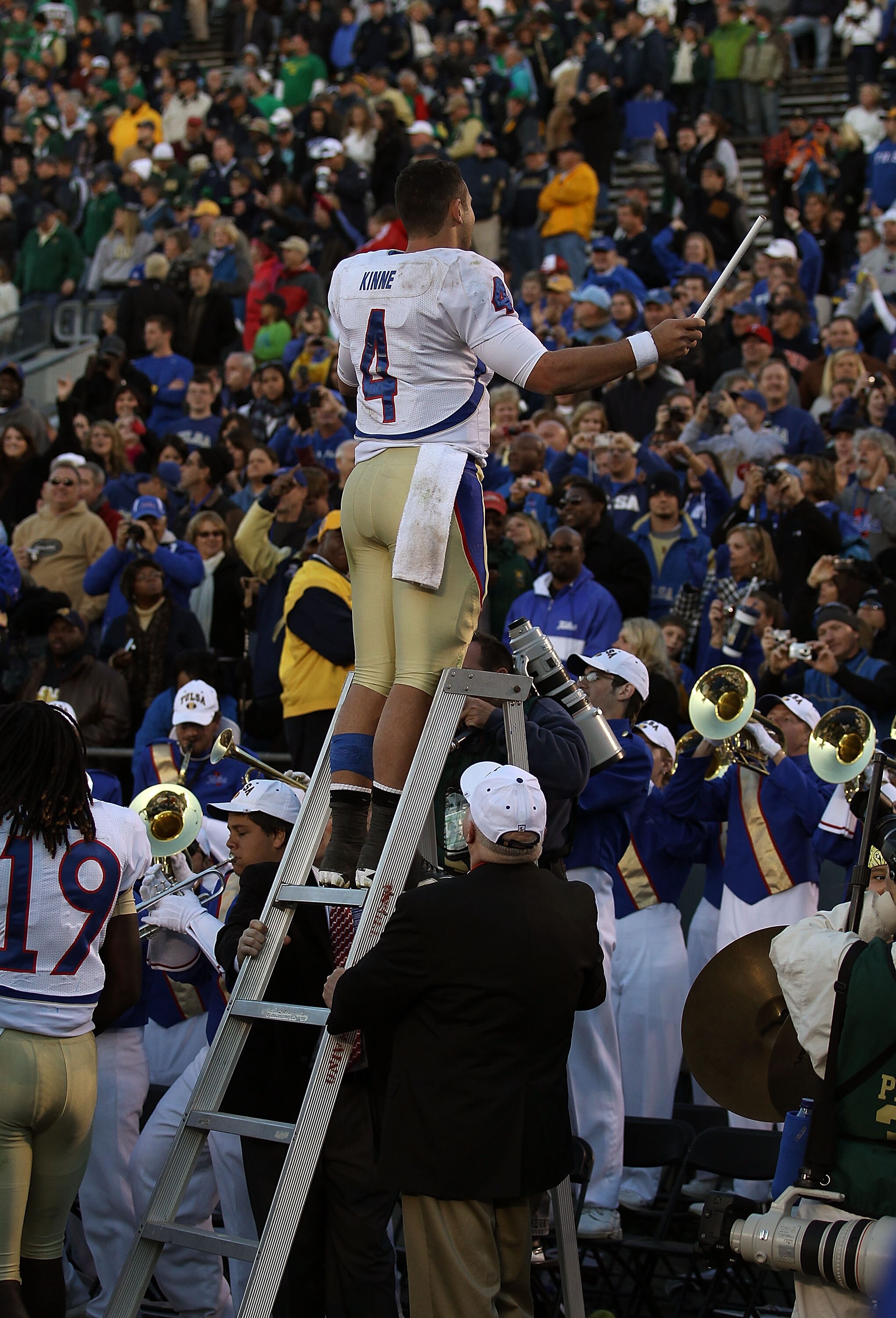 SOUTH BEND, IN - OCTOBER 30: G.J. Kinne #4 of the Tulsa Golden Hurricane conducts the band after a win over the Notre Dame Fighting Irish at Notre Dame Stadium on October 30, 2010 in South Bend, Indiana. Tulsa defeated Notre Dame 28-27. (Photo by Jonathan
