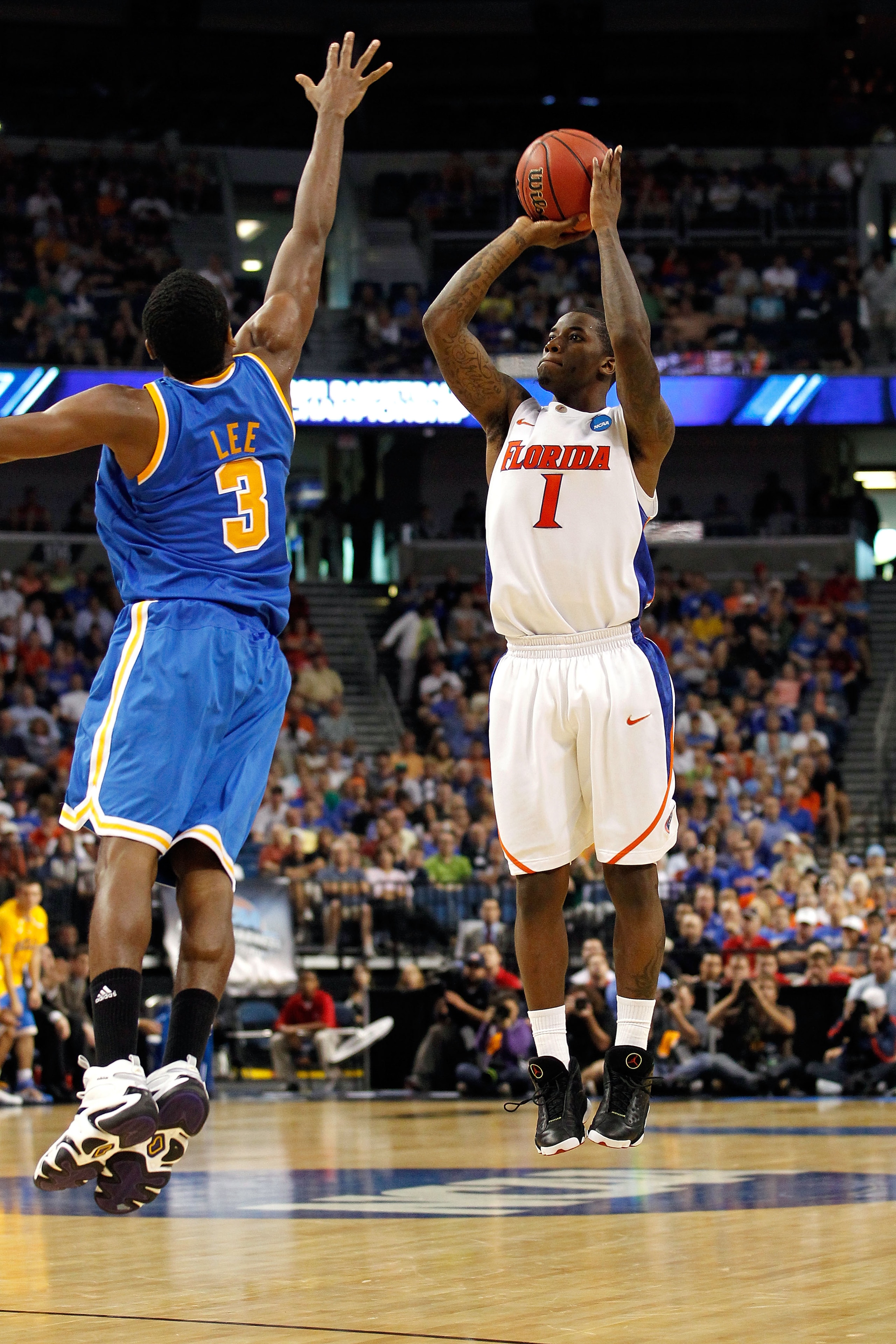 TAMPA, FL - MARCH 19:  Kenny Boynton #1 of the Florida Gators attempts a shot against Malcolm Lee #3 of the UCLA Bruins during the third round of the 2011 NCAA men's basketball tournament at St. Pete Times Forum on March 19, 2011 in Tampa, Florida. Florid