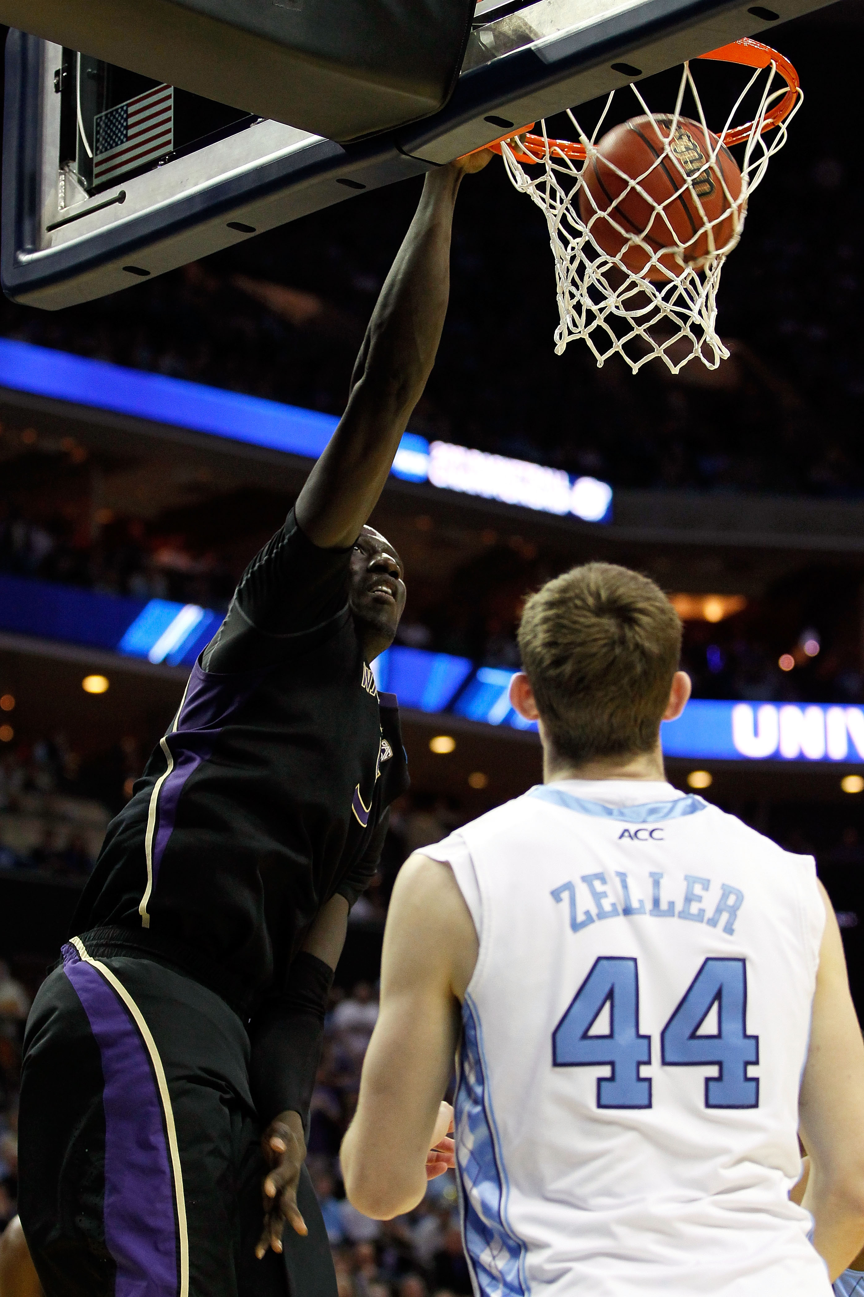 CHARLOTTE, NC - MARCH 20: Aziz N'Diaye #5 of the Washington Huskies dunks the ball over Tyler Zeller #44 of the North Carolina Tar Heels in the first half during the third round of the 2011 NCAA men's basketball tournament at Time Warner Cable Arena on M
