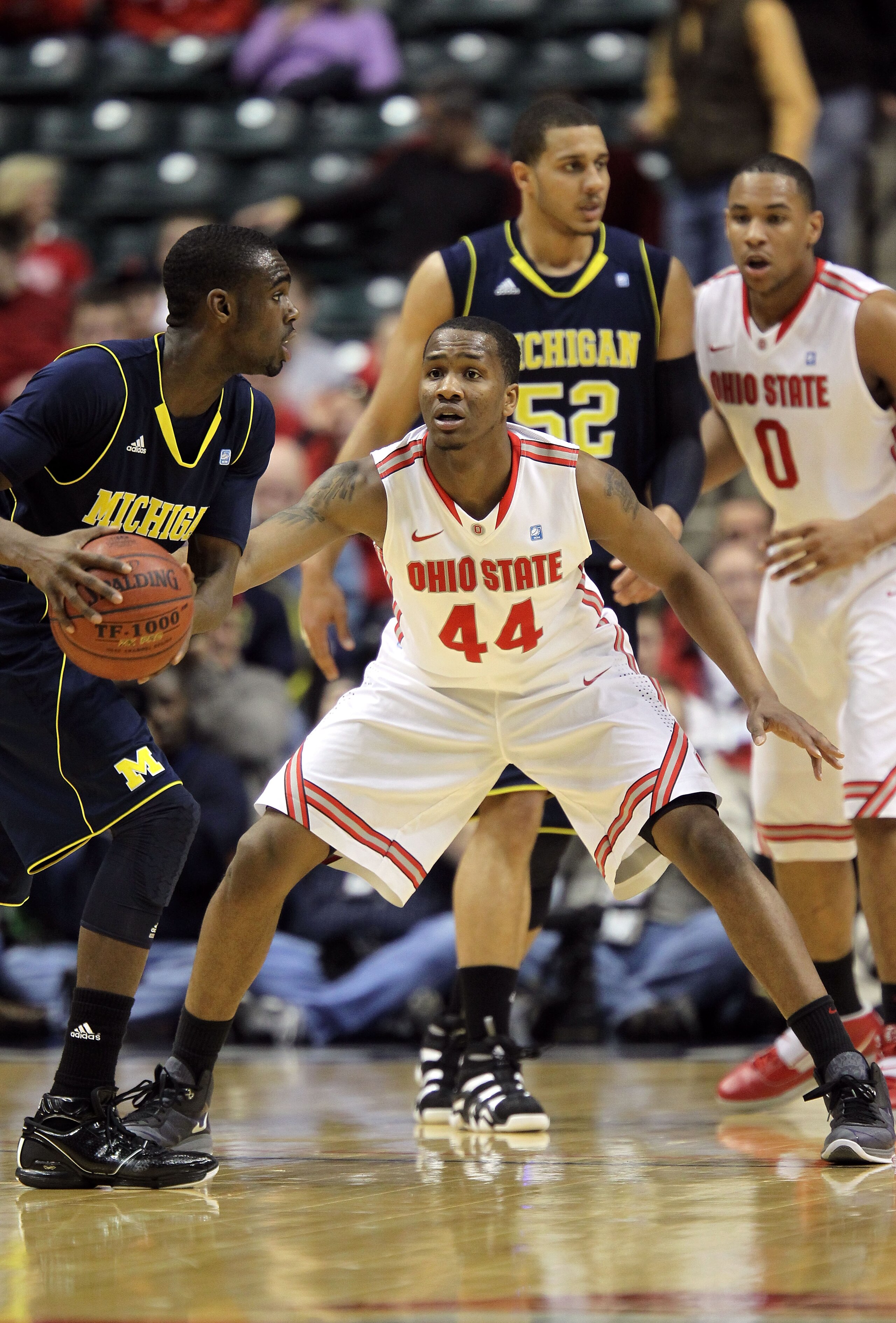 INDIANAPOLIS, IN - MARCH 12:  William Buford #44 of the Ohio State Buckeyes defends against Michigan Wolverines during the semifinals of the 2011 Big Ten Men's Basketball Tournament at Conseco Fieldhouse on March 12, 2011 in Indianapolis, Indiana. Ohio St