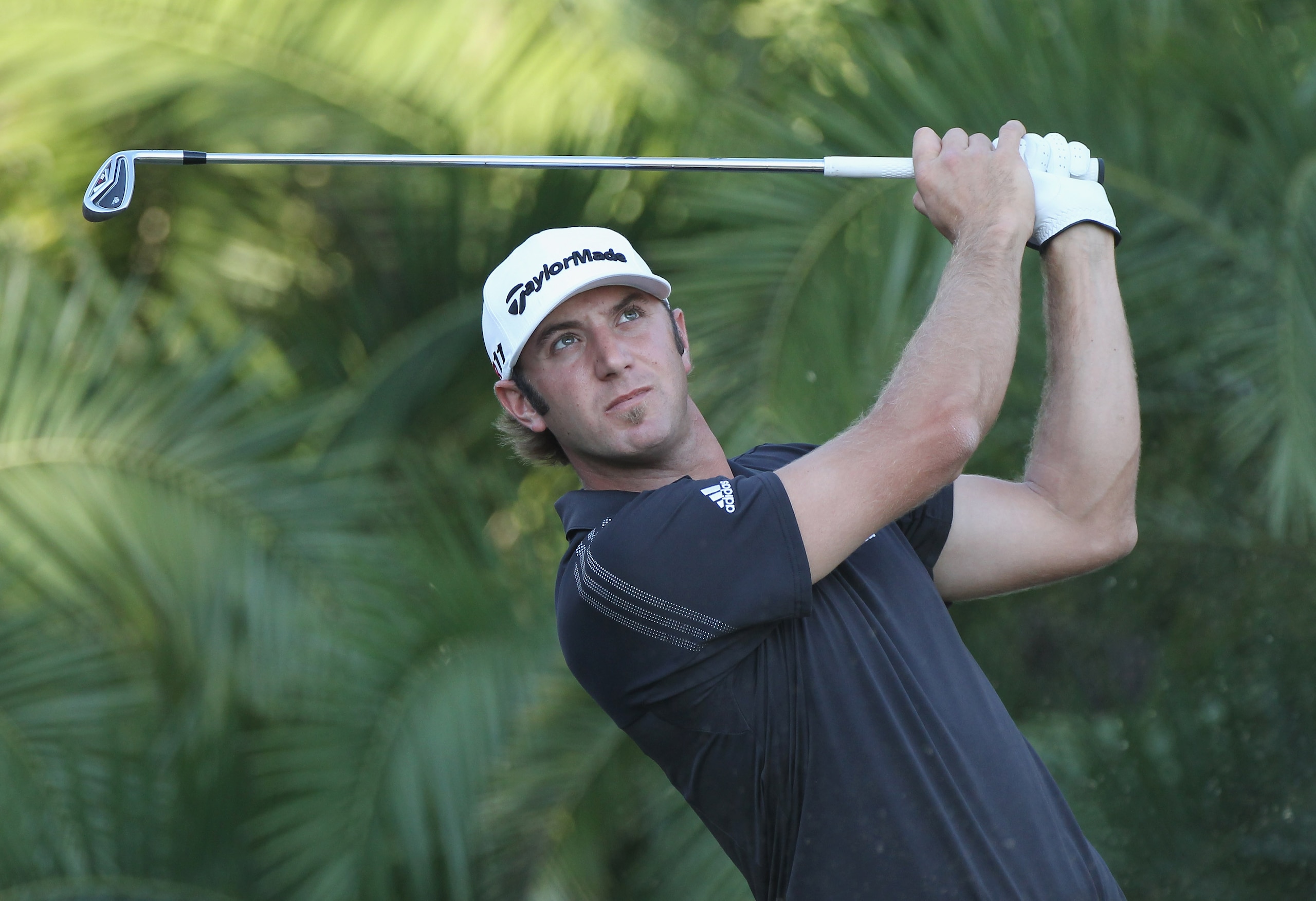 DORAL, FL - MARCH 13:  Dustin Johnson watches a shot during the final round of the 2011 WGC- Cadillac Championship at the TPC Blue Monster at the Doral Golf Resort and Spa on March 13, 2011 in Doral, Florida.  (Photo by Sam Greenwood/Getty Images)