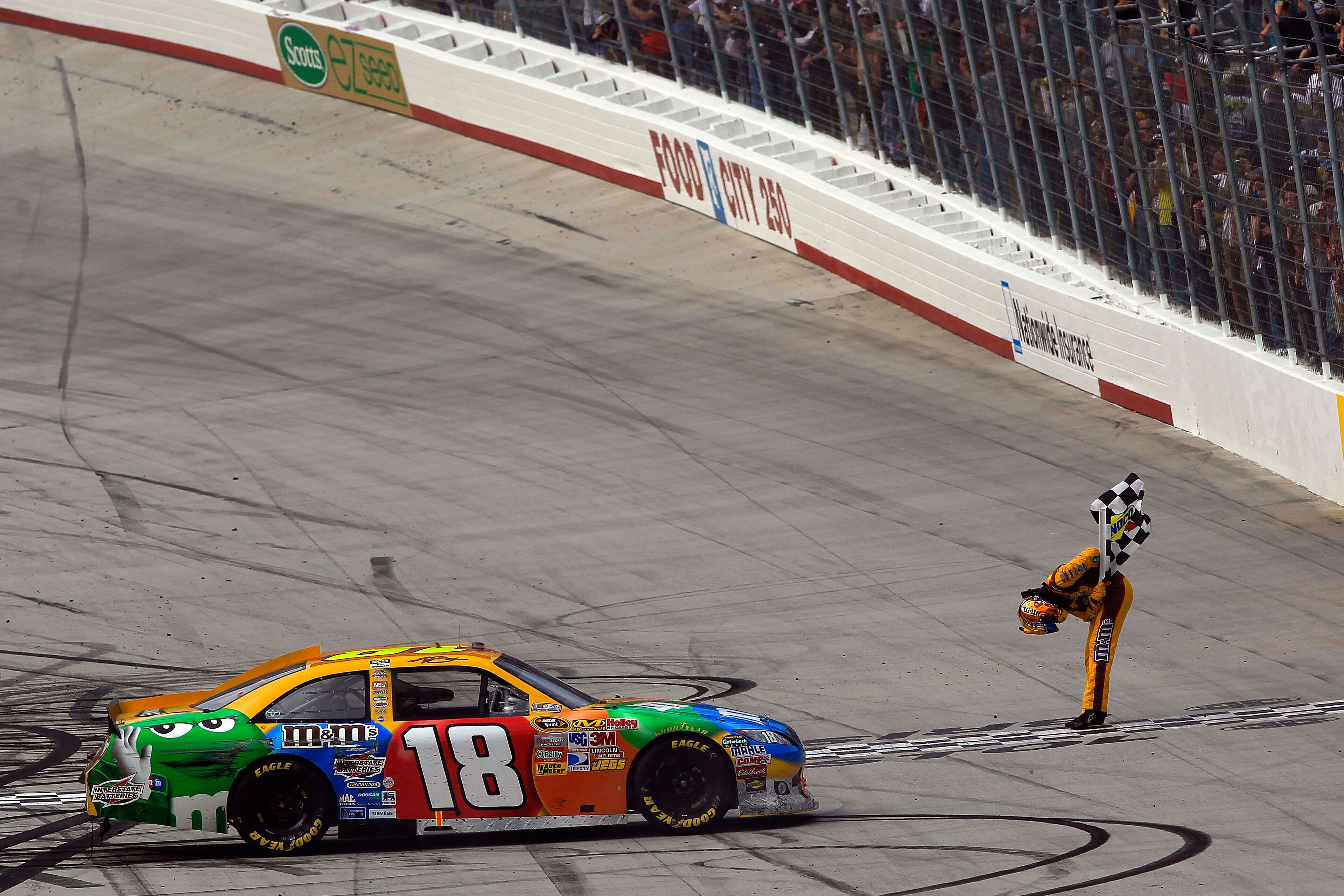 BRISTOL, TN - MARCH 20:  Kyle Busch, driver of the #18 M&M's Toyota, celebrates with the checkered flag after winning the NASCAR Sprint Cup Series Jeff Byrd 500 Presented By Food City at Bristol Motor Speedway on March 20, 2011 in Bristol, Tennessee.  (Ph