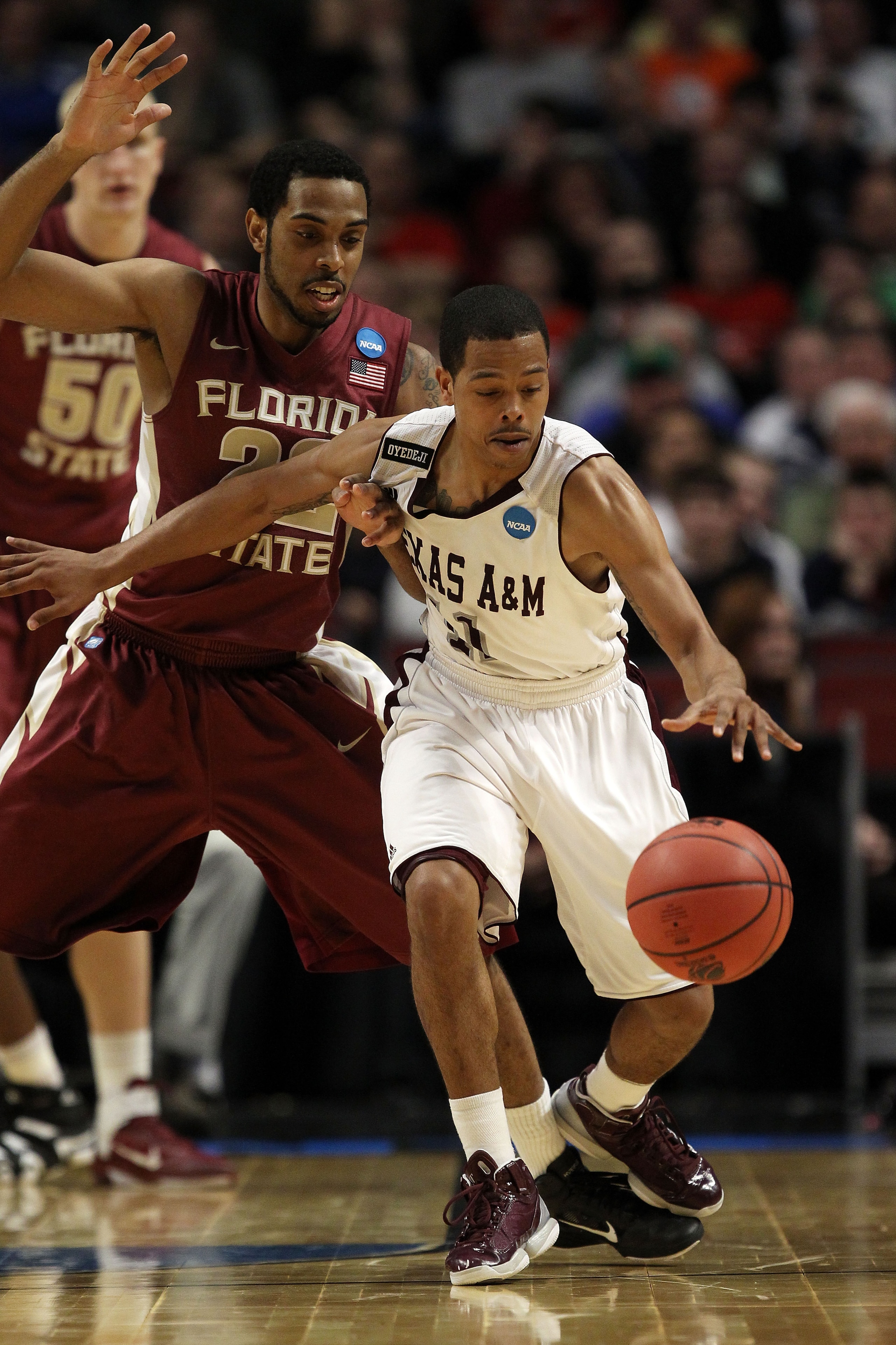 CHICAGO, IL - MARCH 18: B.J. Holmes #11 of the Texas A&M Aggies controls the ball against Derwin Kitchen #22 of the Florida State Seminoles in the second half during the second round of the 2011 NCAA men's basketball tournament at the United Center on Mar
