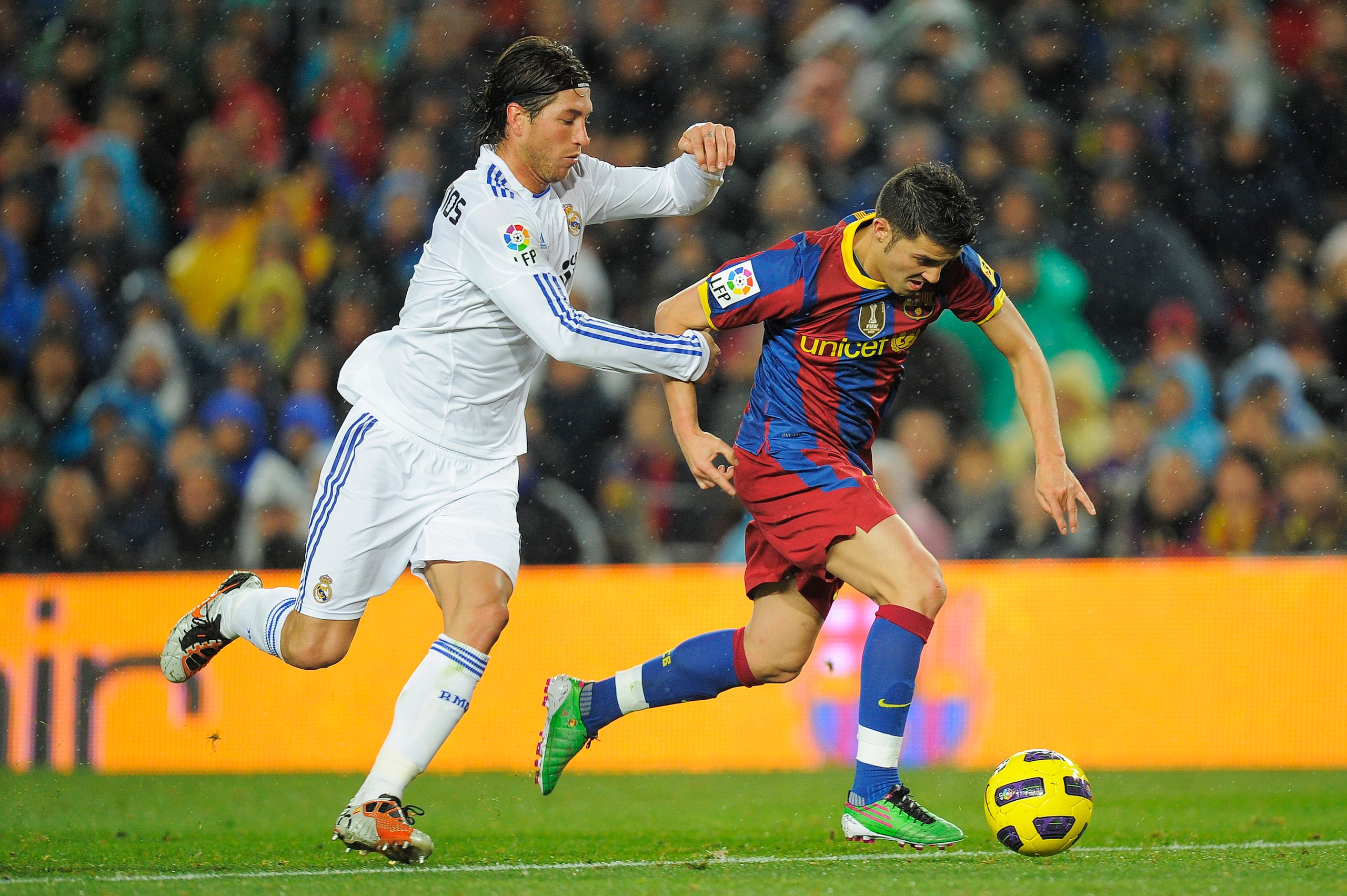 BARCELONA, SPAIN - NOVEMBER 29:  David Villa of Barcelona (R) vies for the ball with Sergio Ramos of Real Madrid during the La Liga match between Barcelona and Real Madrid at the Camp Nou Stadium on November 29, 2010 in Barcelona, Spain.  Barcelona won th