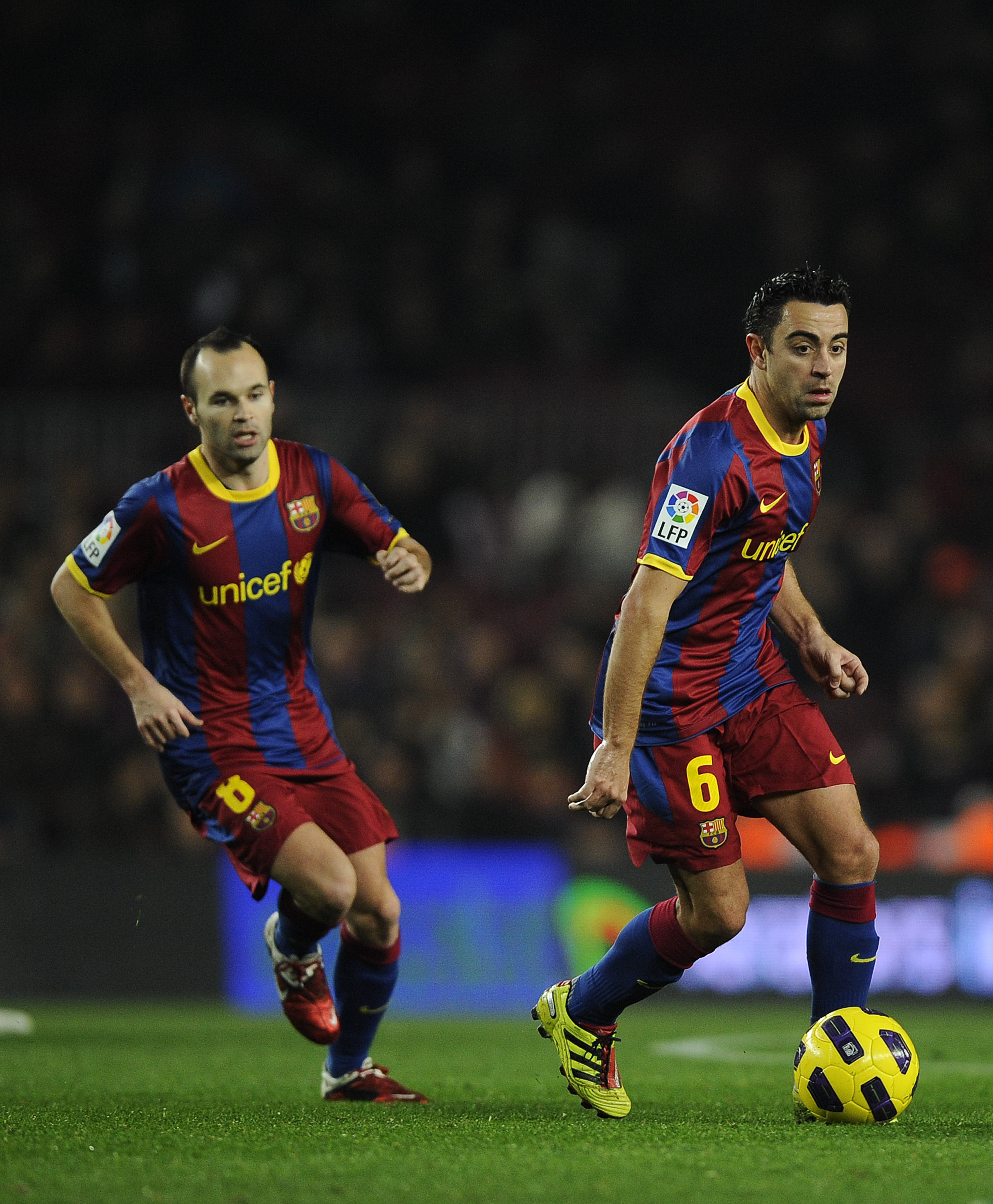 BARCELONA, SPAIN - JANUARY 12:  Xavi Hernandez of FC Barcelona (R) and his teammate Andres Iniesta in action during the Copa del Rey quarter final first leg match between FC Barcelona and Betis at Camp Nou on January 12, 2011 in Barcelona, Spain. Barcelon